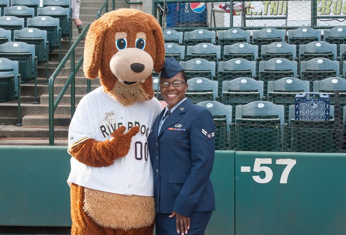 Airman 1st Class Kahdija Slaughter, 628th Air Base Wing broadcaster, poses for a photo with Charlie T. RiverDog during Military Appreciation Night Aug. 19, 2015, at Joseph P. Riley Jr. ballpark in Charleston, S.C. The Charleston RiverDogs hosted Military Appreciation Night to show their support for the local military. (U.S. Air Force photo/ Staff Sgt. William A. O’Brien)