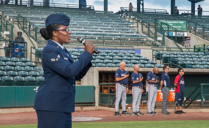 Airman 1st Class Kahdija Slaughter, 628th Air Base Wing broadcaster, sings the National Anthem during Military Appreciation Night Aug. 19, 2015, at Joseph P. Riley Jr. ballpark in Charleston, S.C. The Charleston RiverDogs hosted Military Appreciation Night to show their support for the local military. (U.S. Air Force photo/ Staff Sgt. William A. O’Brien)