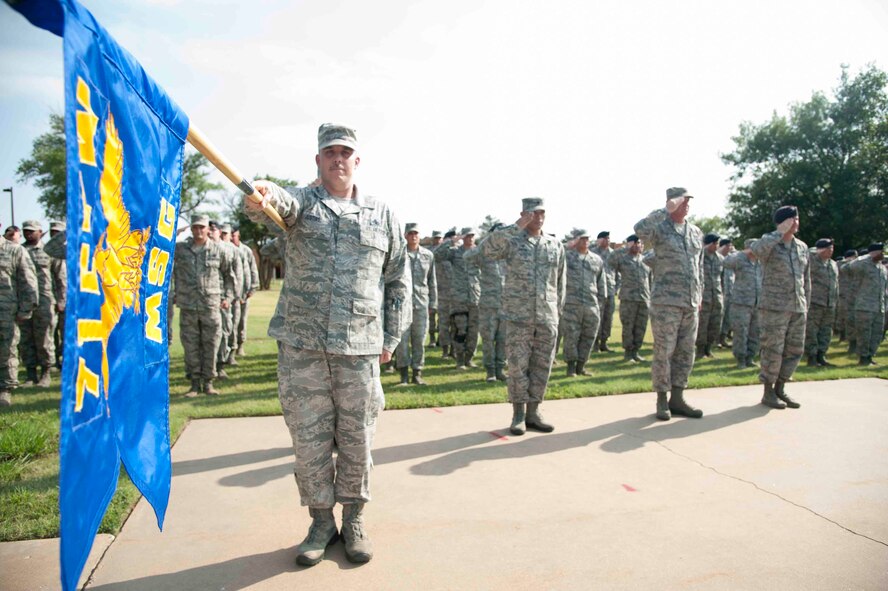 Master Sgt. David Justiss, Mission Support Group 1st Sgt., holds the 71st MSG guidon at salute along with Airmen from the 71st MSG during retreat Aug. 24 outside building 500. Approximately 100 Airmen stood in formation during retreat. (U.S. Air Force photo / Staff Sgt. Nancy Falcon)