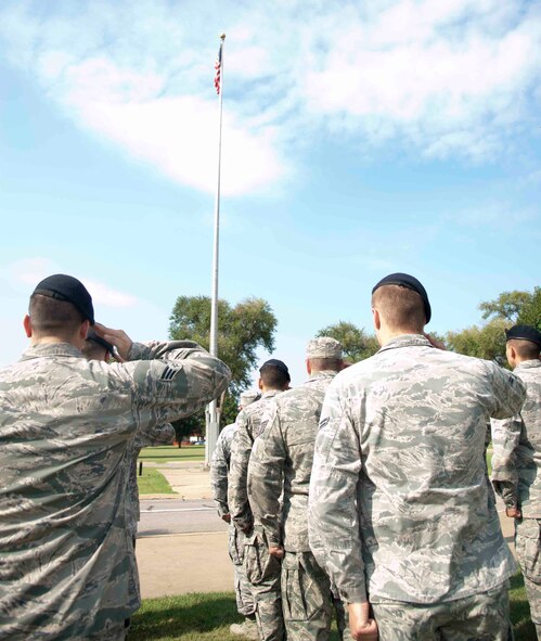 Airmen from the 71st Mission Support Group salute during retreat Aug. 24 outside building 500. Approximately 100 Airmen from the 71st MSG stood in formation during retreat. (U.S. Air Force photo / Staff Sgt. Nancy Falcon)