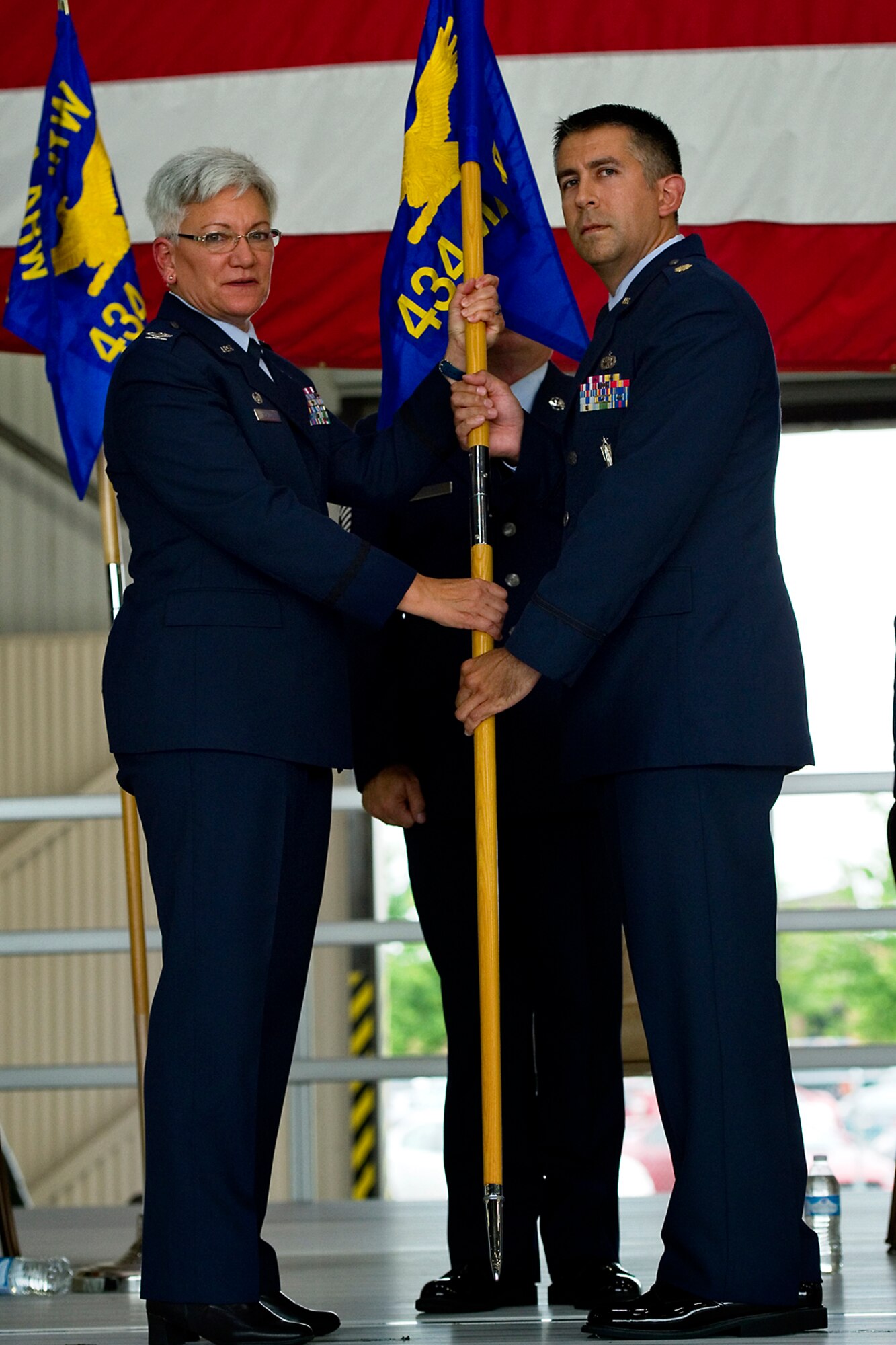 Col. Anna Schulte, 434th Maintenance Group commander, presents a 434th Aircraft Maintenance Squadron guidon to Major John Valdez III, 434th AMXS commander, during a change of command ceremony at Grissom Air Reserve Base, Ind., Aug. 9, 2015. The 434th AMXS is one of two squadrons and one flight that fall under the 434th Maintenance Group including over 560 personnel with a mission to provide vital support to the 434th Air Refueling Wing. (U.S. Air Force photo/Senior Airman Jami Lancette)