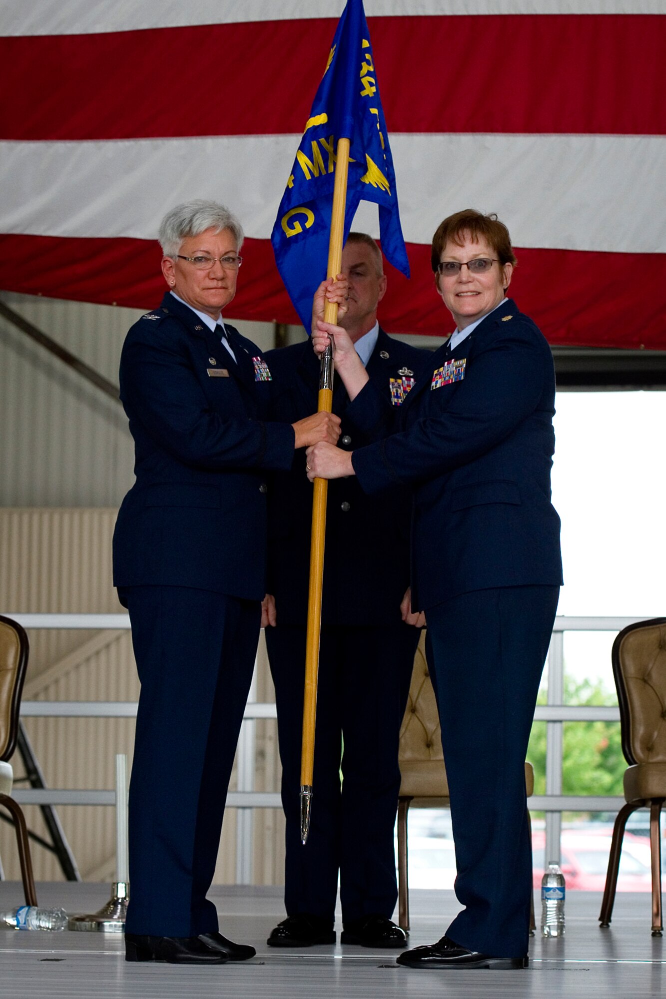 Col. Anna Schulte, 434th Maintenance Group commander, presents a 434th Maintenance Squadron guidon to Major Amy Johannsen, 434th MXS commander, during a change of command ceremony at Grissom Air Reserve Base, Ind., Aug. 9, 2015. The 434th MXS is one of two squadrons and one flight that fall under the 434th Maintenance Group including over 560 personnel with a mission to provide vital support to the 434th Air Refueling Wing. (U.S. Air Force photo/Senior Airman Jami Lancette)