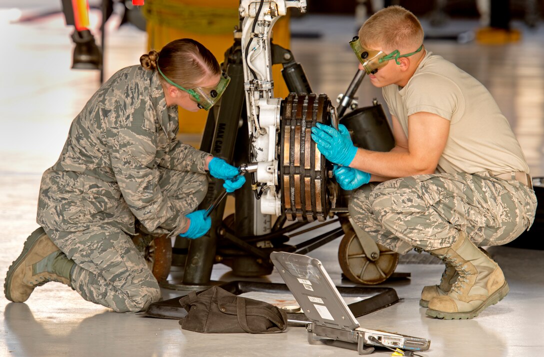 U.S. Airman Larry Etter and Airman Cassandra Sides, 362nd Training Squadron students, determine tire serviceability by removing and installing the main landing wheel, tire, and brake assembly on an F-15C Eagle, Aug. 25, 2015, at Sheppard Air Force Base, Texas. Instructors teach students proper maintenance procedures to ensure Airmen are highly trained and proficient at ensuring aircraft are in perfect working order. (U.S. Air Force photo by Danny Webb/Released)
