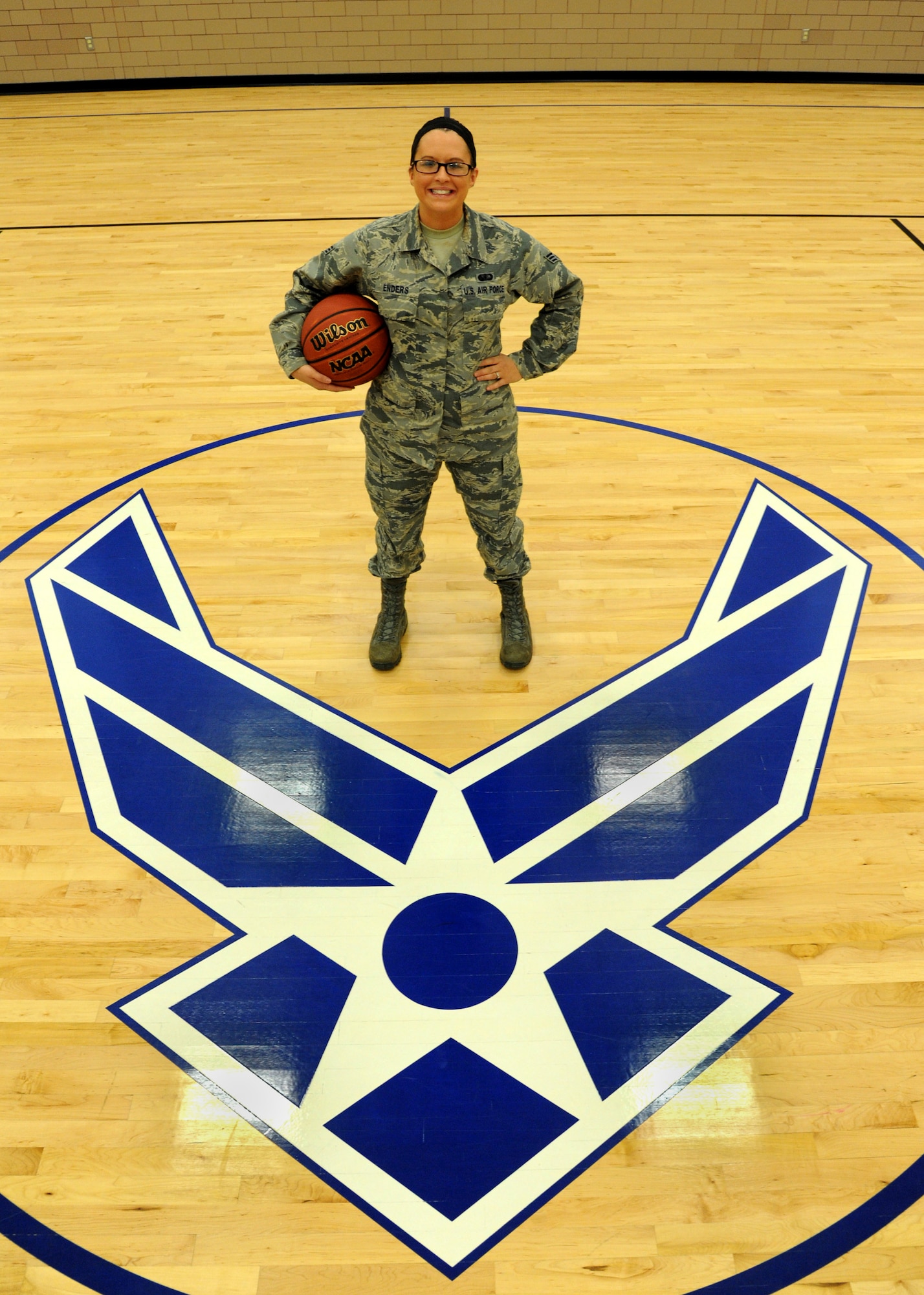 Senior Airman Aleiah Enders, 319th Force Support Squadron fitness specialist, poses at mid-court of the fitness center August 25, 2015 on Grand Forks Air Force Base, North Dakota. Enders was named the Warrior of the Week for the fourth week of August 2015. (U.S. Air Force photo by Airman 1st Class Ryan Sparks/Released)