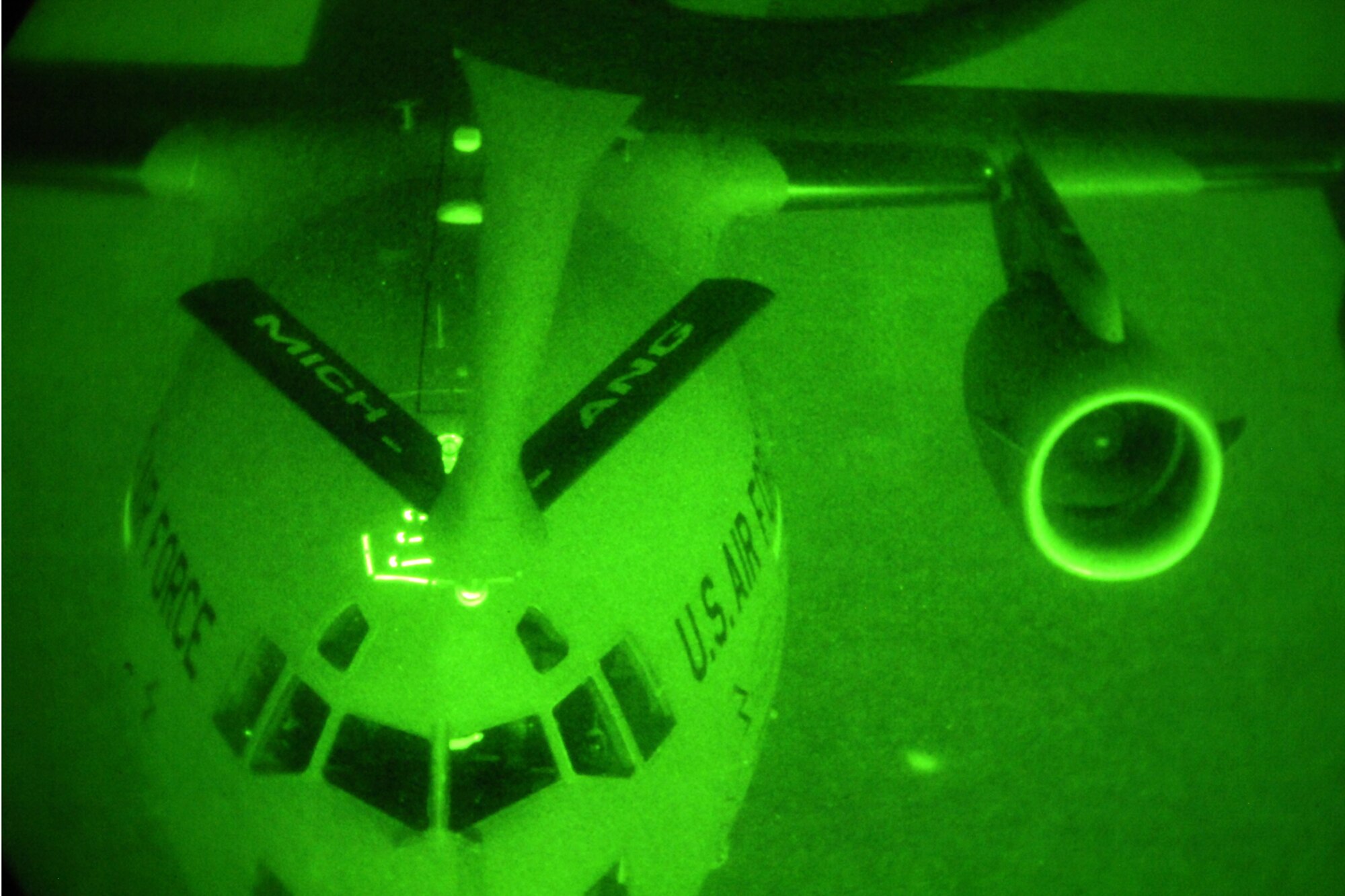 150825-Z-EZ686-232 -- A KC-135 Stratotanker from the 127th Air Refueling Group, Selfridge Air National Guard Base, Mich., is seen via a night-vision filter as it performs a night time refueling for a C-17 Globemaster III from the 445th Airlift Wing during a training mission on Aug. 25, 2015. The KC-135 Stratotanker is operated by the 127th Air Refueling Group, flown by the 171st Air Refueling Squadron and maintained by the 191st Maintenance and 191st Aircraft Maintenance squadrons. (U.S. Air National Guard photo by Master Sgt David Kujawa / Released)