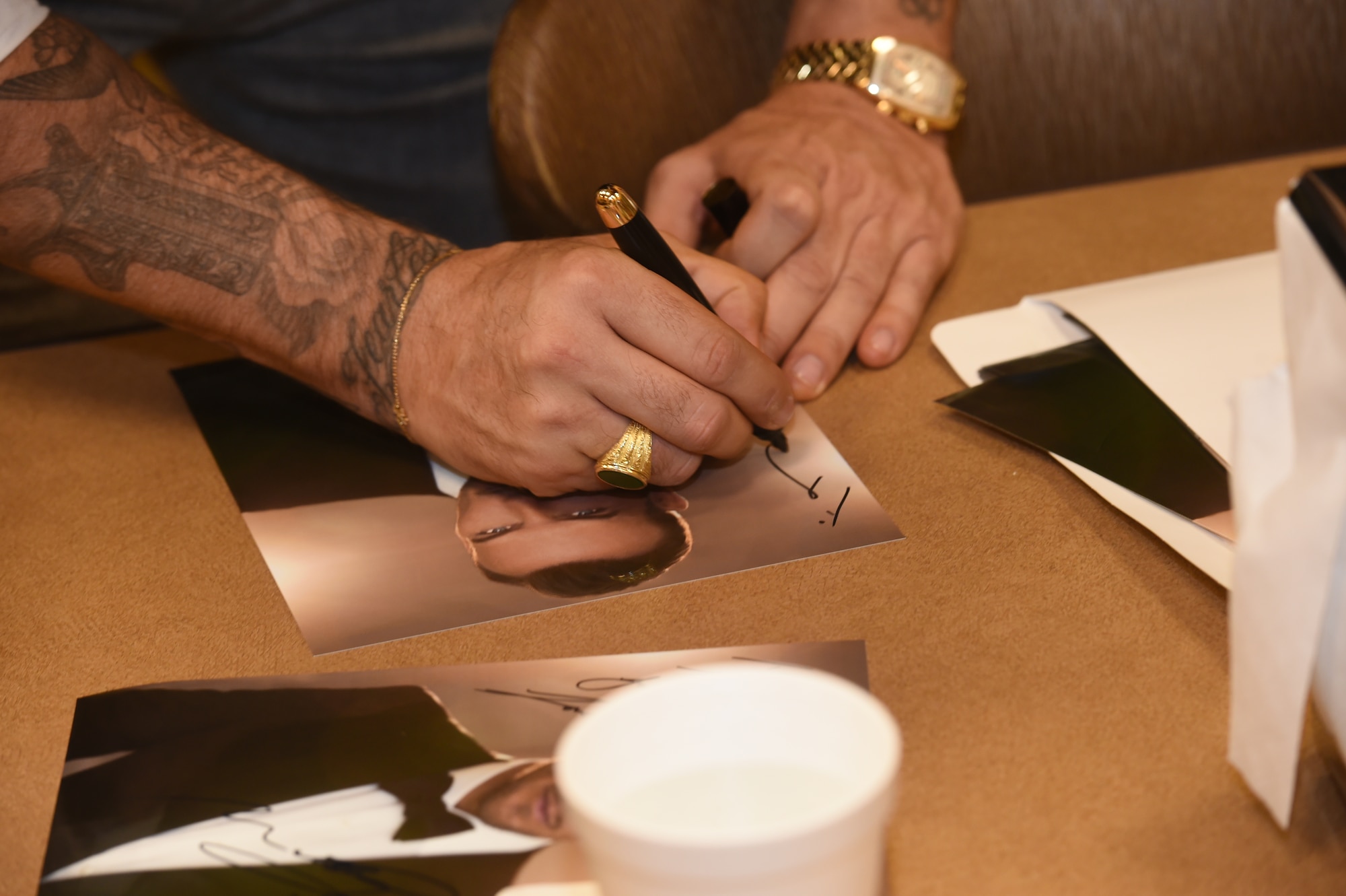 Matt Goss, singer and songwriter, signs autographs for Airmen while he visited the 432nd Wing/432nd Air Expeditionary Wing at Creech Air Force Base, Nevada, as part of a USO event on Aug. 24, 2015. Matt is a Los Angeles based musician who performs for audiences on the Las Vegas strip. (U.S. Air Force photo by Senior Airman Adarius Petty) 