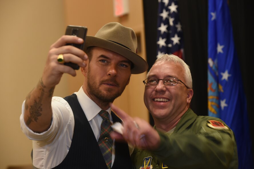 Matt Goss, singer and songwriter, takes a selfie with an Airman while he visited the 432nd Wing/432nd Air Expeditionary Wing at Creech Air Force Base, Nevada, as part of a USO event on Aug. 24, 2015. Matt is a Los Angeles based musician who performs for audiences on the Las Vegas strip. (U.S. Air Force photo by Senior Airman Adarius Petty) 