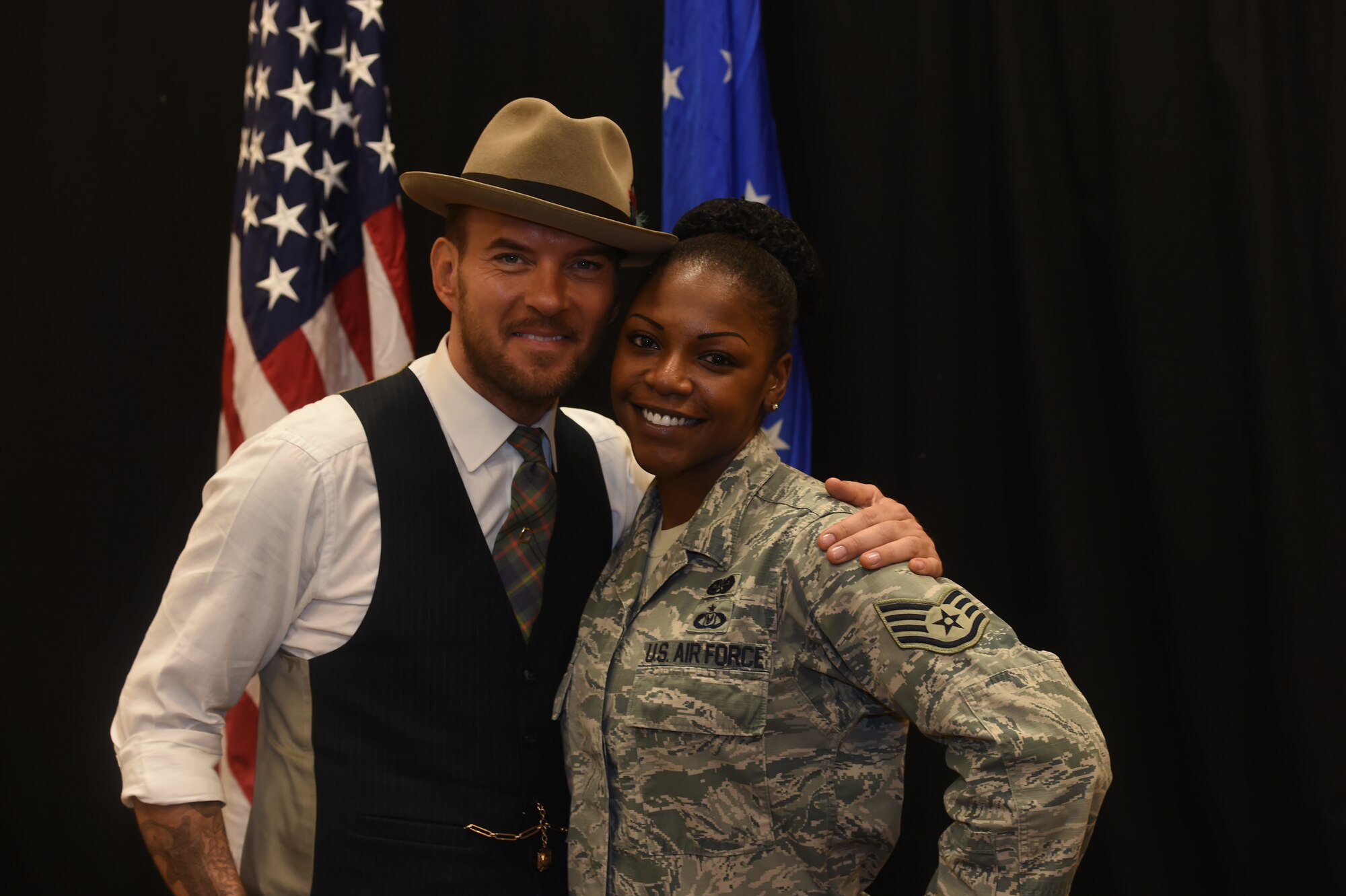 Matt Goss, singer and songwriter, poses with Staff Sgt. Tiffany Austin, U.S. Air Force Warfare Center NCO in-charge of Creech Legal Annex, as part of a USO event at Creech Air Force Base, Nevada, on Aug. 24, 2015. Matt is a Los Angeles based musician who performs for audiences on the Las Vegas strip. (U.S. Air Force photo by Senior Airman Adarius Petty)