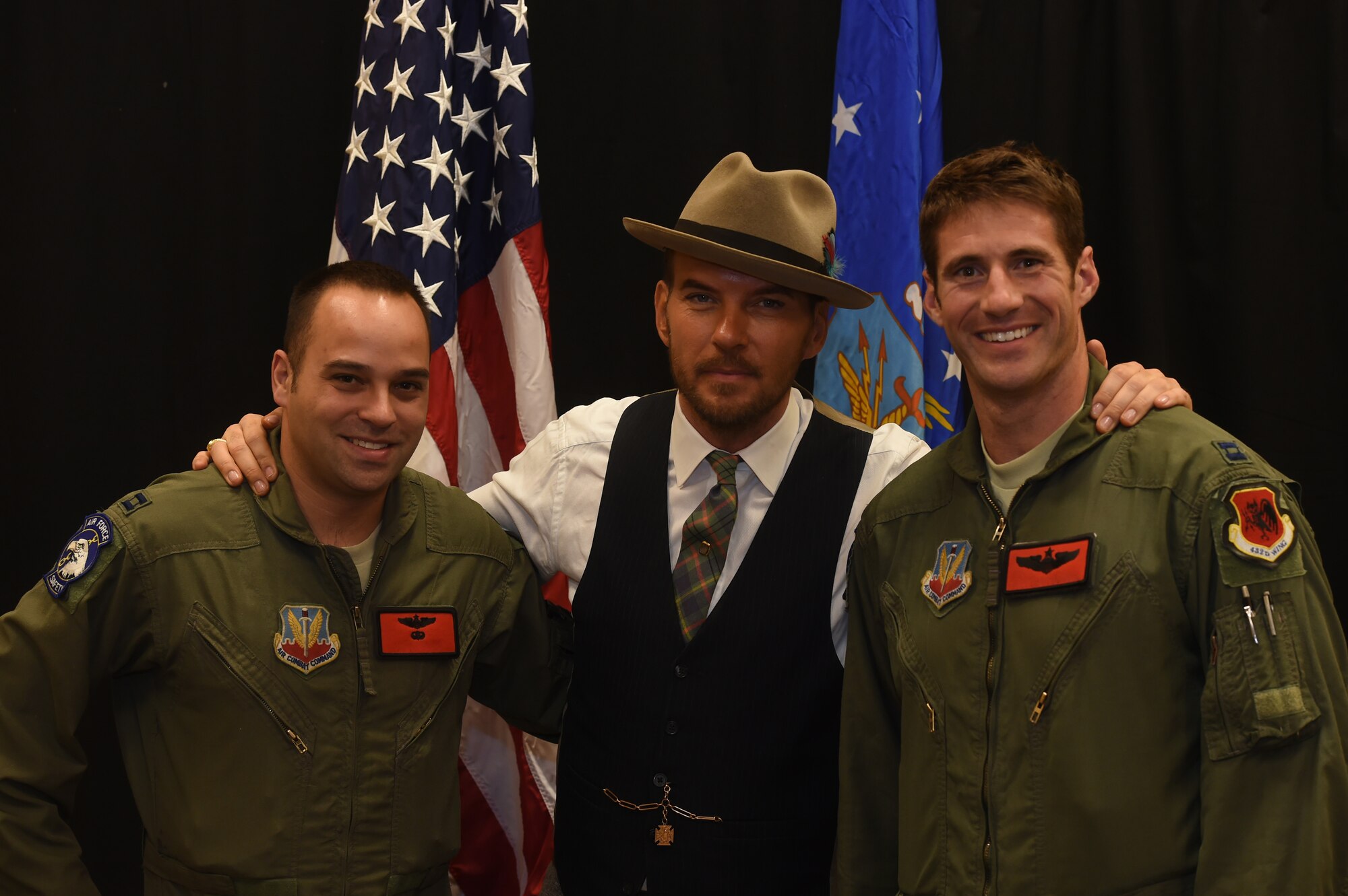 Matt Goss, singer and songwriter, poses with Airmen from the 432nd Wing/432nd Air Expeditionary Wing at Creech Air Force Base, Nevada, as part of a USO event on Aug. 24, 2015. Matt is a Los Angeles based musician who performs for audiences on the Las Vegas strip. (U.S. Air Force photo by Senior Airman Adarius Petty) 