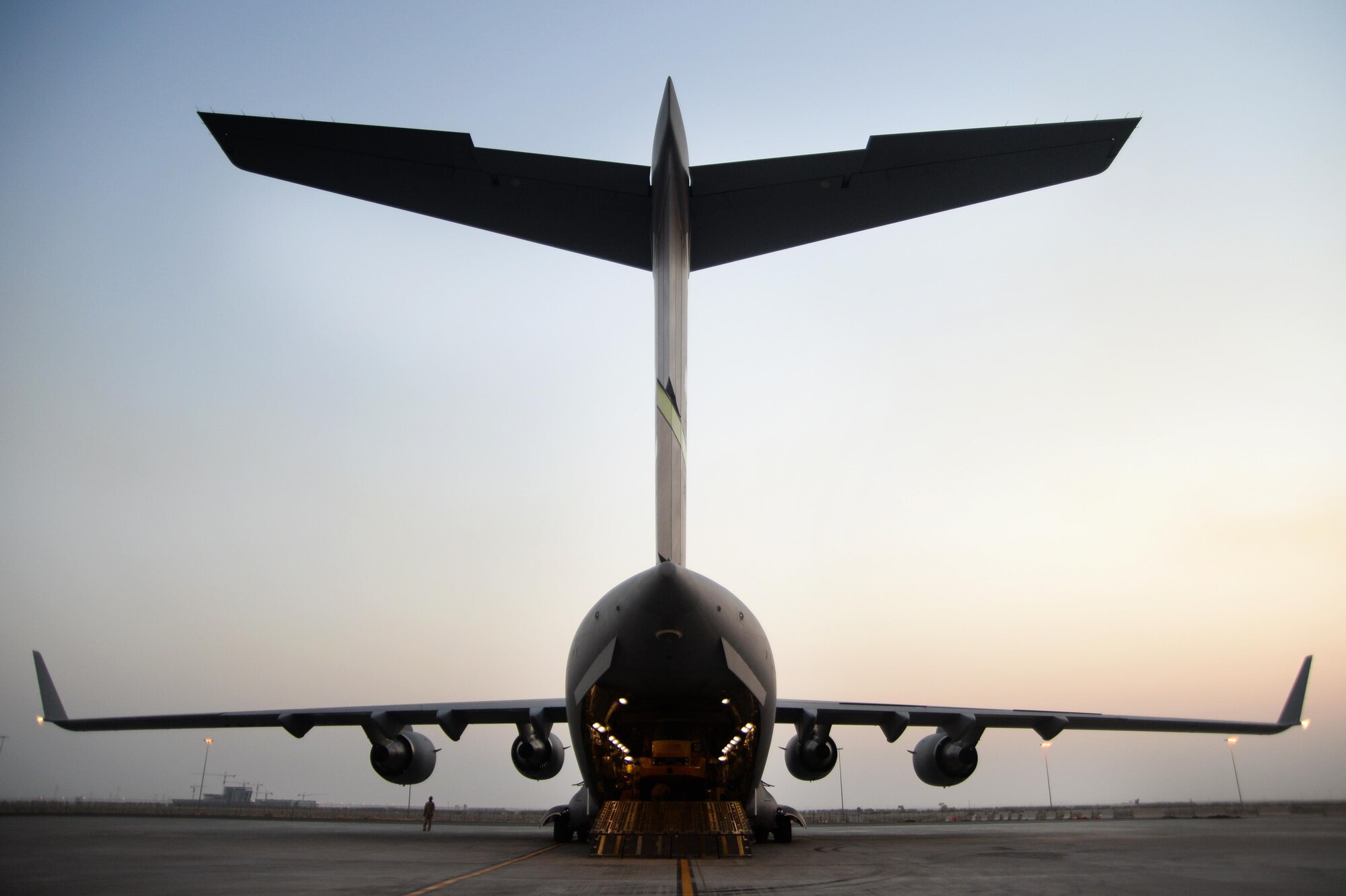 U.S. Air Force members prepare to unload cargo from a C-17 Globemaster III in support of Operation Inherent Resolve in Kuwait, August 14, 2015. OIR is the military intervention against Daesh. (U.S. Air Force photo by Staff Sgt. Sandra Welch) 