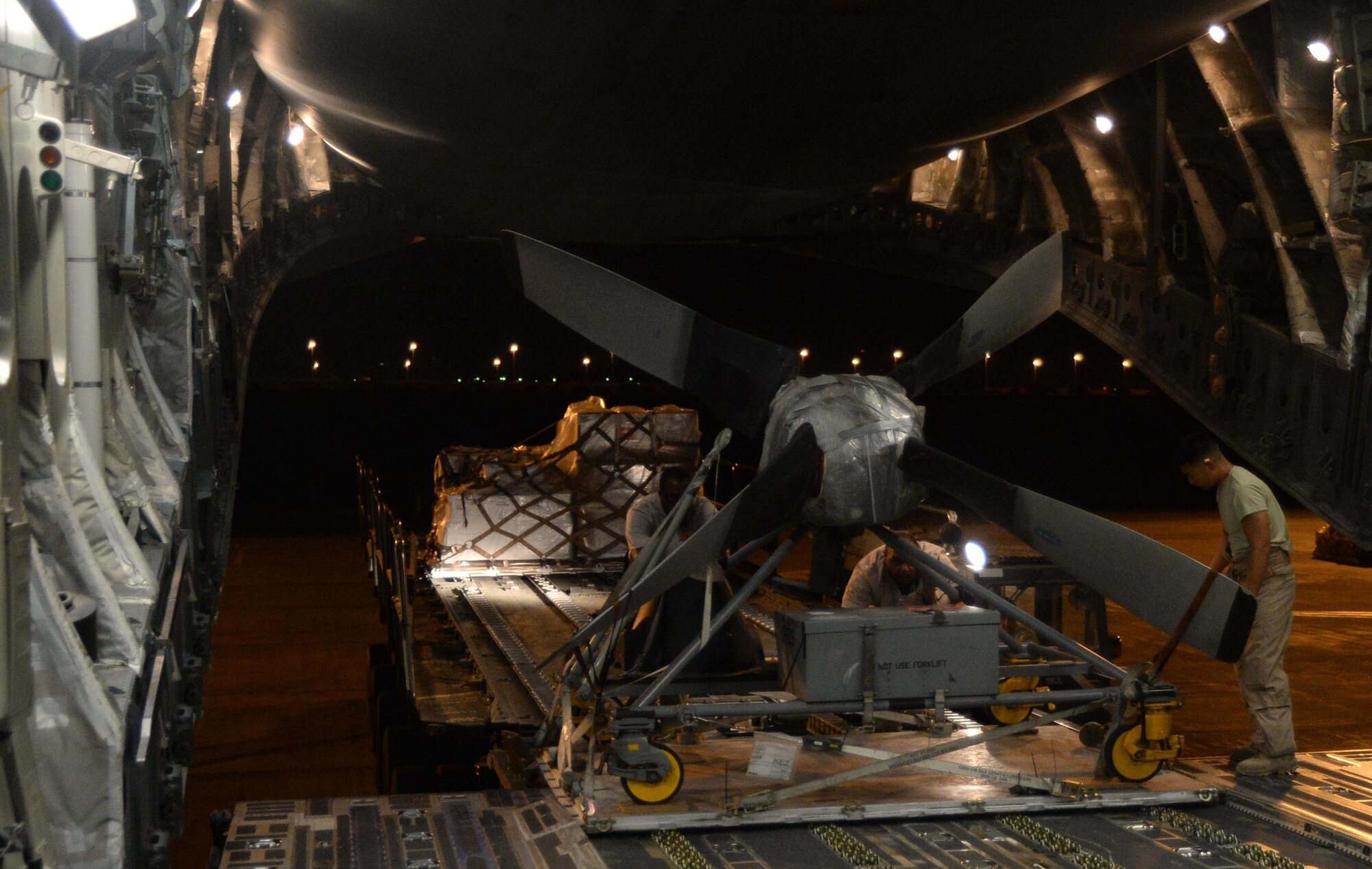 U.S. Air Force members load cargo on a C-17 Globemaster III in support of Operation Inherent Resolve in Kuwait, August 14, 2015. OIR is the military intervention against Daesh. (U.S. Air Force photo by Staff Sgt. Sandra Welch) 