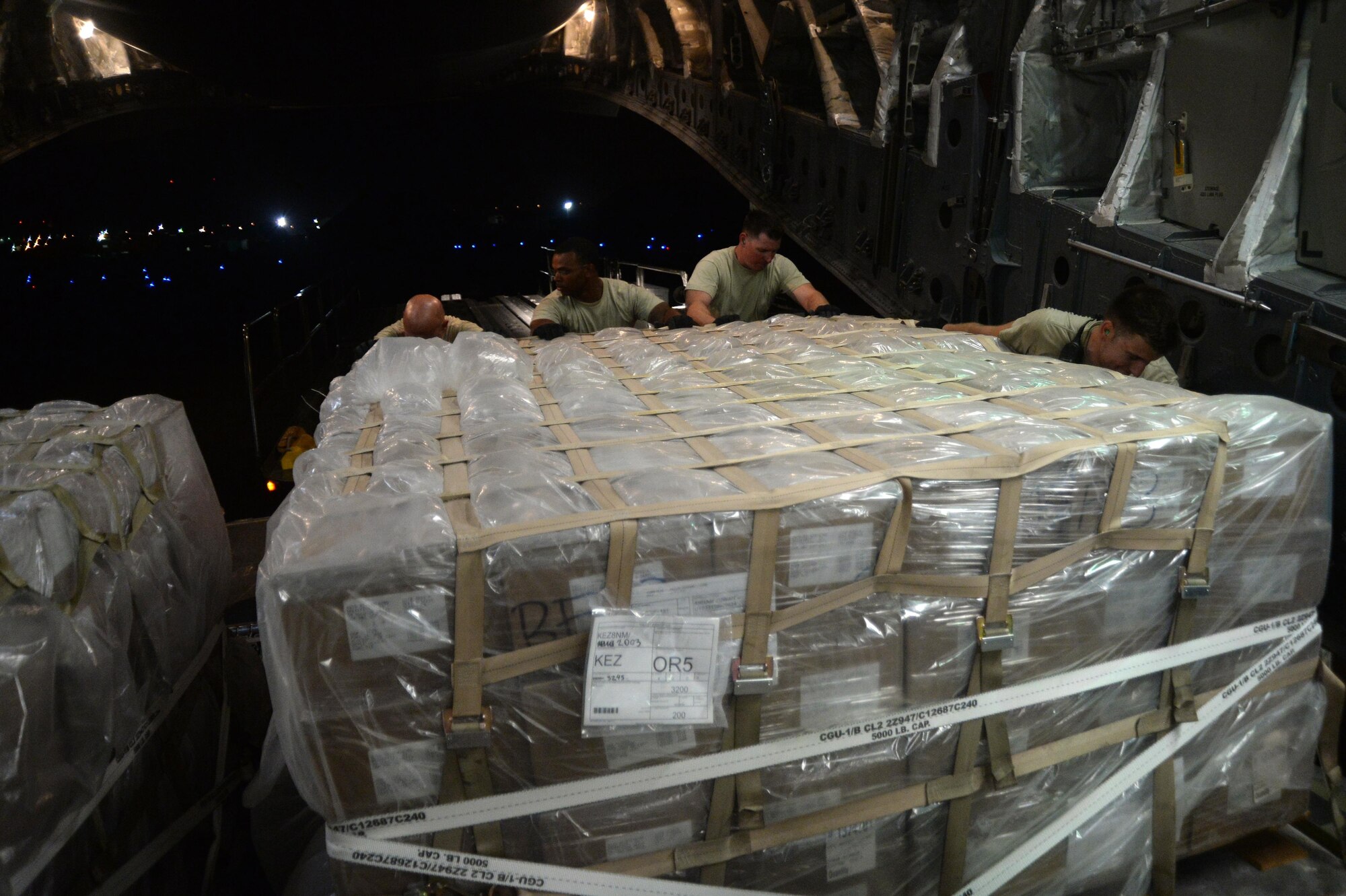 U.S. Air Force members load cargo on a C-17 Globemaster III in support of Operation Inherent Resolve in Kuwait, August 14, 2015. OIR is the military intervention against Daesh. (U.S. Air Force photo by Staff Sgt. Sandra Welch) 