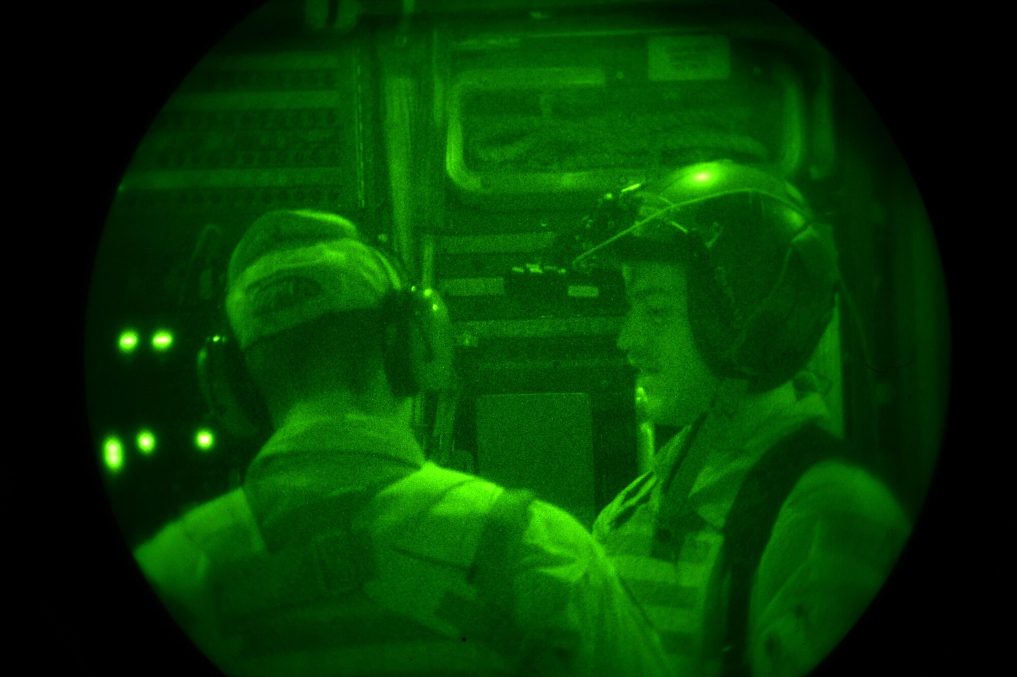 U.S. Air Force Senior Airman Garth, discuss an unload plan with Senior Airman Rebecca, 816th Expeditionary Airlift Squadron loadmaster, during a cargo delivery in support of Operation Inherent Resolve on a C-17 Globemaster III in Southwest Asia, August 14, 2015. OIR is the military intervention against Daesh. (U.S. Air Force photo by Staff Sgt. Sandra Welch) 