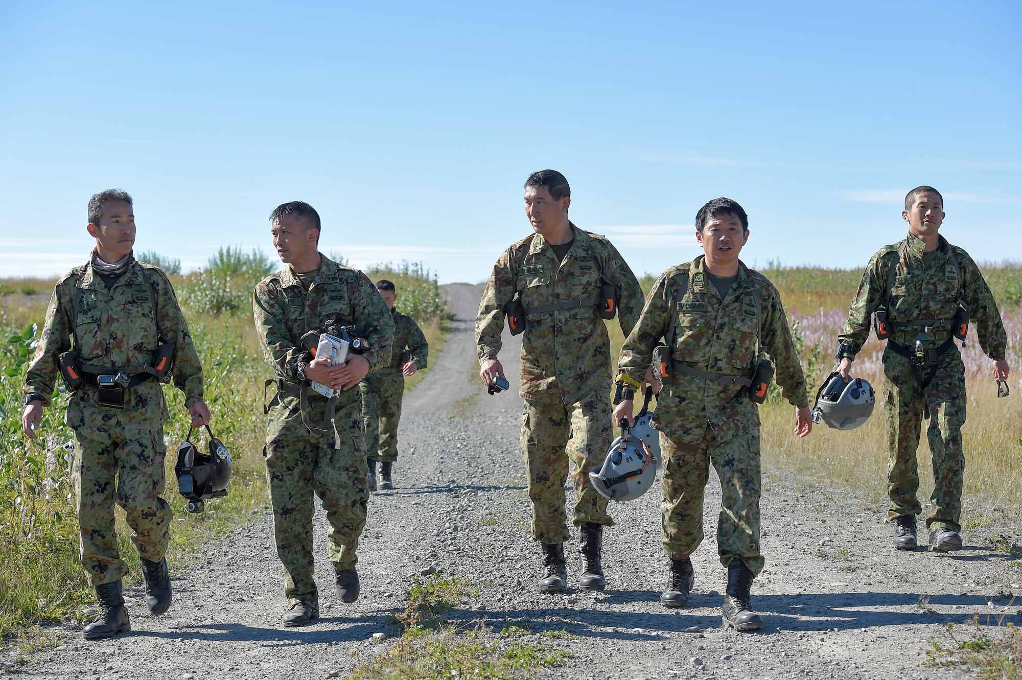 Japanese Ground Self-Defense Force paratroopers proceed to a rendezvous before conducting high altitude-low opening jump training over Malemute drop zone, Joint Base Elmendorf-Richardson, Alaska, Aug. 24, 2015. JGSDF and U.S. Army paratroopers conducted the practice jump utilizing Royal Australian and U.S. Air Force aircraft as part of Pacific Airlift Rally 2015, a biennial, multilateral tactical military symposium designed to enhance military airlift interoperability and cooperation between nations of the Pacific region for future humanitarian missions. (U.S. Air Force photo/Alejandro Pena)