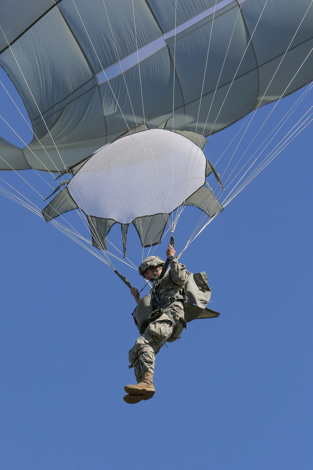 Pvt. Richard Kellogg, a native of Atlanta, Ga., assigned to 1st Battalion (Airborne), 501st Infantry Regiment, 4th Infantry Brigade Combat Team (Airborne), 25th Infantry Division, U.S. Army Alaska, descends during a practice jump over Malemute drop zone, Joint Base Elmendorf-Richardson, Alaska, Aug. 24, 2015. Japanese Ground Self-Defense Force and U.S. Army paratroopers conducted the practice jump utilizing Royal Australian and U.S. Air Force aircraft as part of Pacific Airlift Rally 2015, a biennial, multilateral tactical military symposium designed to enhance military airlift interoperability and cooperation between nations of the Pacific region for future humanitarian missions. (U.S. Air Force photo/Alejandro Pena)