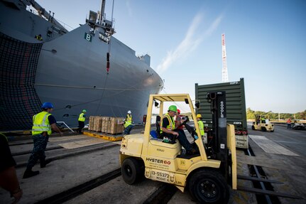 Sailors, Marines and civilians with the Navy Munitions Command Unit Charleston and Marine Corps Systems Command upload cargo to the USNS Lewis and Clark (T-AKE-1) March, 25, 2015, at Naval Weapons Station Wharf Alpha, Charleston, S.C. The Lewis and Clark is a replenishment naval vessel. In 2012, USNS Lewis and Clark became one of 12 ships that comprise the United States Marine Corps Maritime Prepositioning Program. Prepositioning ships provides quick and efficient movement of military equipment/supplies between operating areas without reliance on other nations' transportation networks. These ships assure U.S. regional combatant commanders they will have what they need to quickly respond in a crisis - anywhere, anytime. (U.S. Air Force photo/Airman 1st Class Clayton Cupit)