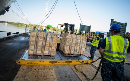 Sailors and Marines with the Navy Munitions Command Unit Charleston and Marine Corps Systems Command upload cargo to the USNS Lewis and Clark (T-AKE-1) on a transport vehicle March, 25, 2015, at Naval Weapons Station Wharf Alpha in Charleston, S.C. The Lewis and Clark is a replenishment naval vessel. In 2012, USNS Lewis and Clark became one of 12 ships that comprise the United States Marine Corps Maritime Prepositioning Program. Prepositioning ships provides quick and efficient movement of military equipment/supplies between operating areas without reliance on other nations' transportation networks. These ships assure U.S. regional combatant commanders they will have what they need to quickly respond in a crisis - anywhere, anytime. (U.S. Air Force photo/Airman 1st Class Clayton Cupit)
