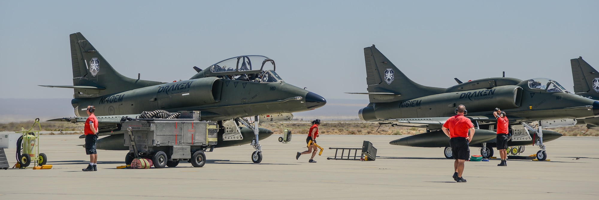 Draken ground crew members pull chocks for the A-4 Skyhawk fleet to taxi out on the runway Aug. 21. (U.S. Air Force photo by Rebecca Amber)