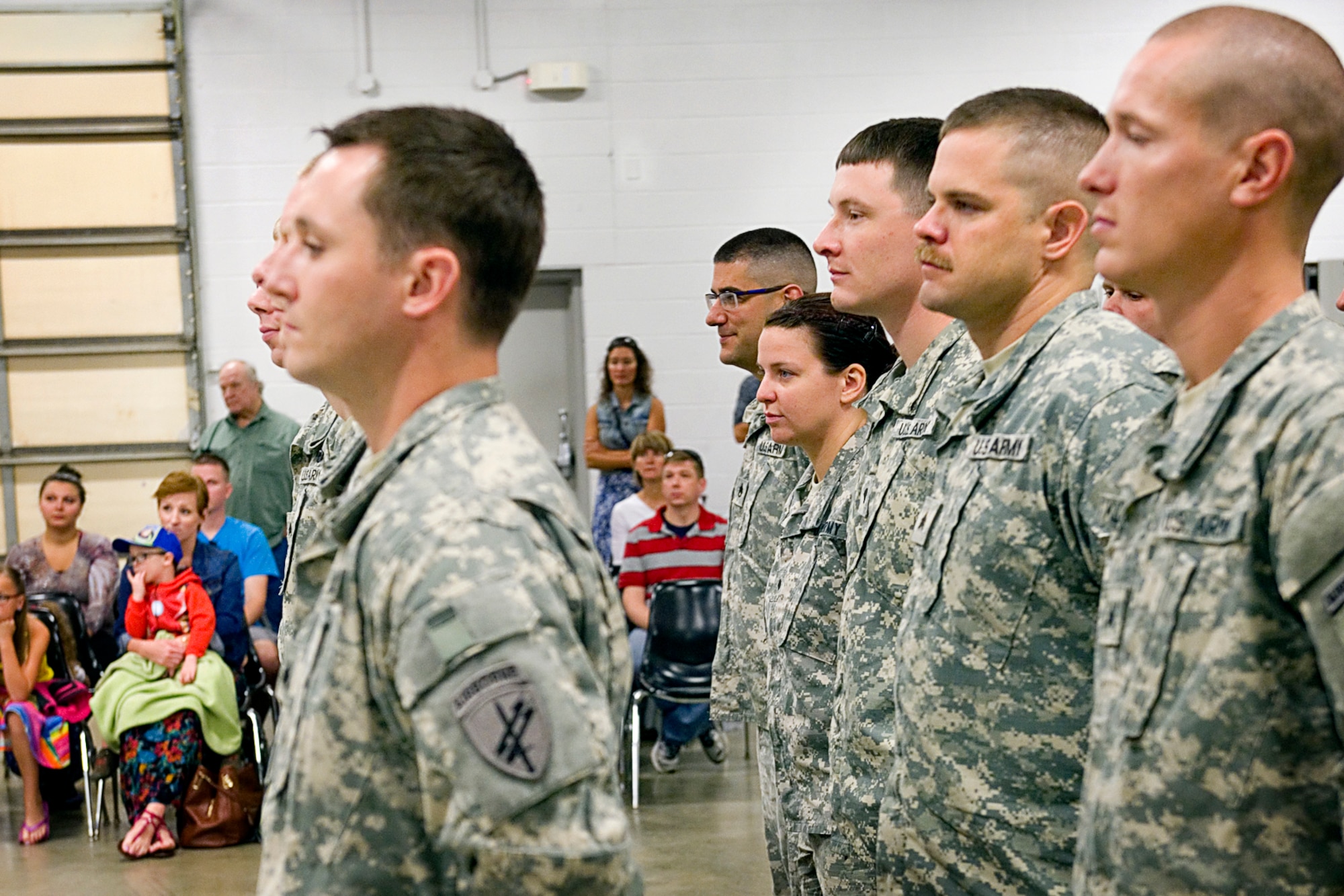 Soldiers from the 316th Psychological Operations Company stand in formation during their deployment processing Aug. 24, 2015 at the Army Reserve Center located at Grissom Air Reserve Base, Ind. Soldiers from the 316th PSOP are preparing for a nine-month deployment supporting the Combined Joint Task Force Horn of Africa. (U.S. Air Force photo/Tech. Sgt. Douglas Hays)