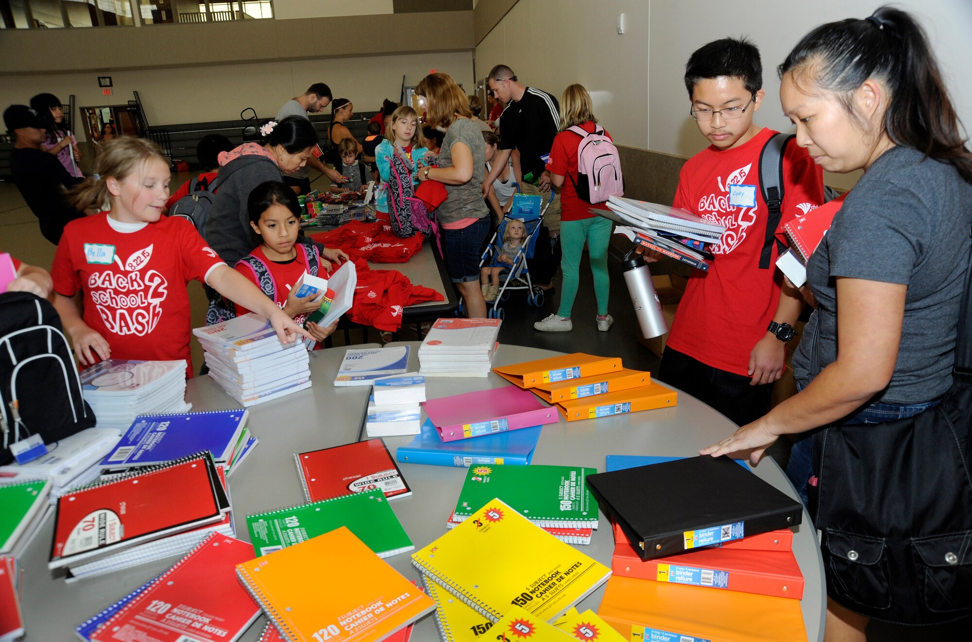 Oregon National Guard military family members attending the Back2School Bash pick up school supplies as the day’s activities conclude at Camp Withycombe, Ore. (U.S. Air National Guard photo by Tech. Sgt. John Hughel, 142nd Fighter Wing Public Affairs/Released)