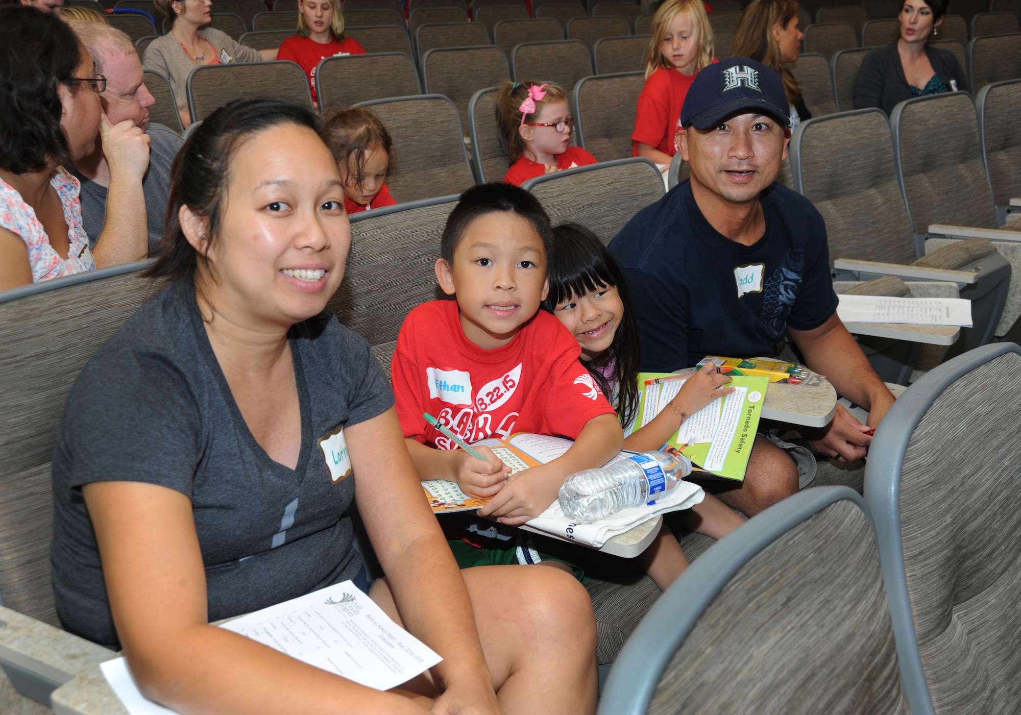 Air National Guard Master Sgt. Todd Le and his family review materials as the Back2School Bash concludes, Aug. 22, 2015, Camp Withycombe, Ore. (U.S. Air National Guard photo by Tech. Sgt. John Hughel, 142nd Fighter Wing Public Affairs/Released)