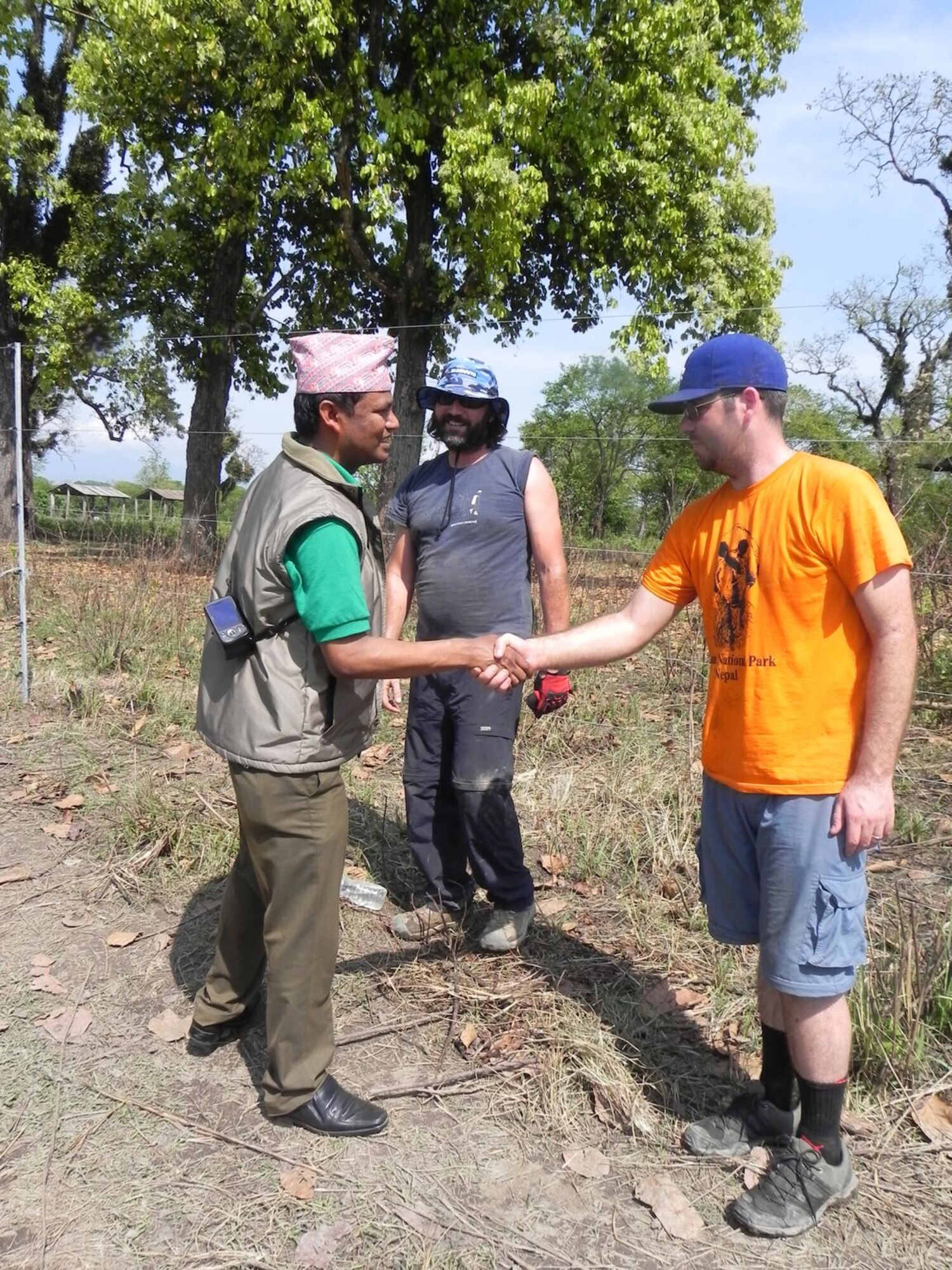 Kamal Jung Kunwar, chief conservation officer and author, greets U.S. Air Force Tech. Sgt. Scott Bettencourt, a pharmacy flight chief with the 55th Medical Support Squadron, while visiting with volunteers building working elephant corrals in Chitwan National Park, Nepal.  An international crew of volunteers came to Chitwan to build the corrals that will replace the chains elephants were tethered to in their off time. (photo courtesy of Elephant Aid International)