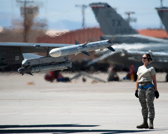 An F-16 Fighting Falcon maintainer completes a final pre-flight inspection of an F-16 assigned to the 457th Fighter Squadron, Naval Air Station Fort Worth Joint Reserve Base, Texas, during Red Flag 15-4 at Nellis Air Force Base, Nev., Aug. 24, 2015. The air training missions are conducted over the 2.9 million acre Nevada Test and Training Range. (U.S. Air Force photo by Senior Airman Thomas Spangler)