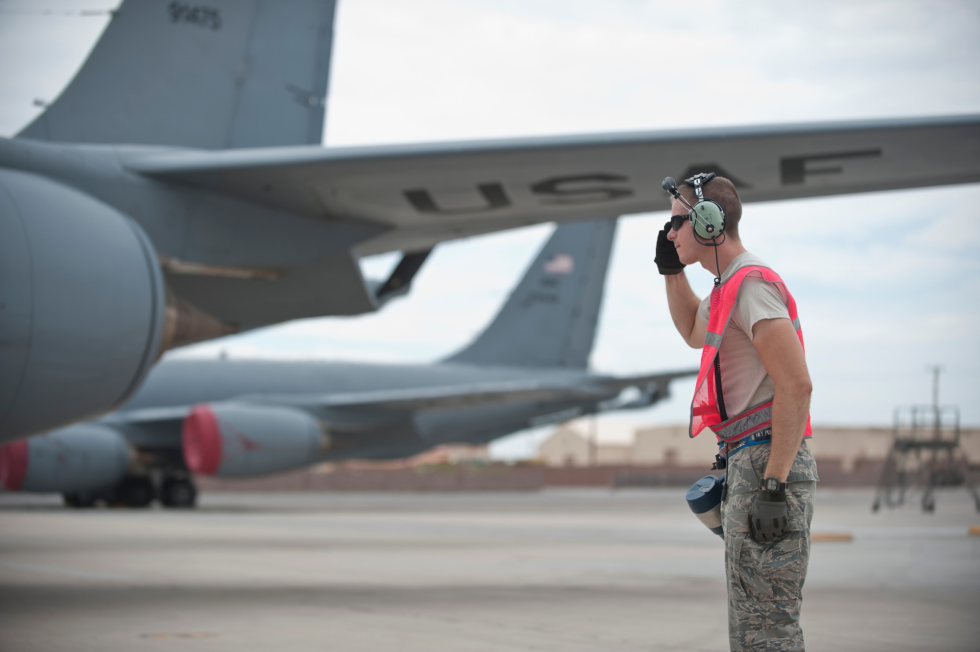 Staff Sgt. Nicholas Mandello, an electronic environment specialist assigned to the 912th Air Refueling Squadron, March Air Reserve Base, Calif., salutes the aircrew of a KC-135 Stratotanker after marshaling it out for a Red Flag 15-4 sortie at Nellis AFB, Nev., Aug. 25, 2015. Red Flag provides an opportunity for active duty, Reserve and Guardsmen aircrew and maintainers to enhance their tactical operational skills alongside units from around the Air Force. (U.S. Air Force photo by Staff Sgt. Siuta B. Ika)