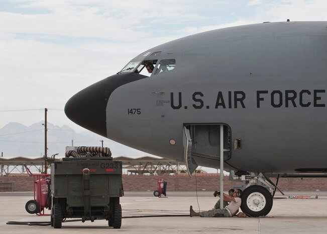 Two maintainers assigned to the 22nd Aircraft Maintenance Squadron, McConnell Air Force Base, Kan., wait for the aircrew of a KC-135 Stratotanker to finish pre-flight inspections prior to a Red Flag 15-4 sortie at Nellis AFB, Nev., Aug. 25, 2015. Red Flag is a realistic combat training exercise involving the air, space and cyber forces of the U.S. and its allies, and is conducted on the vast bombing and gunnery ranges on the Nevada Test and Training Range during day and night operations. (U.S. Air Force photo by Staff Sgt. Siuta B. Ika)