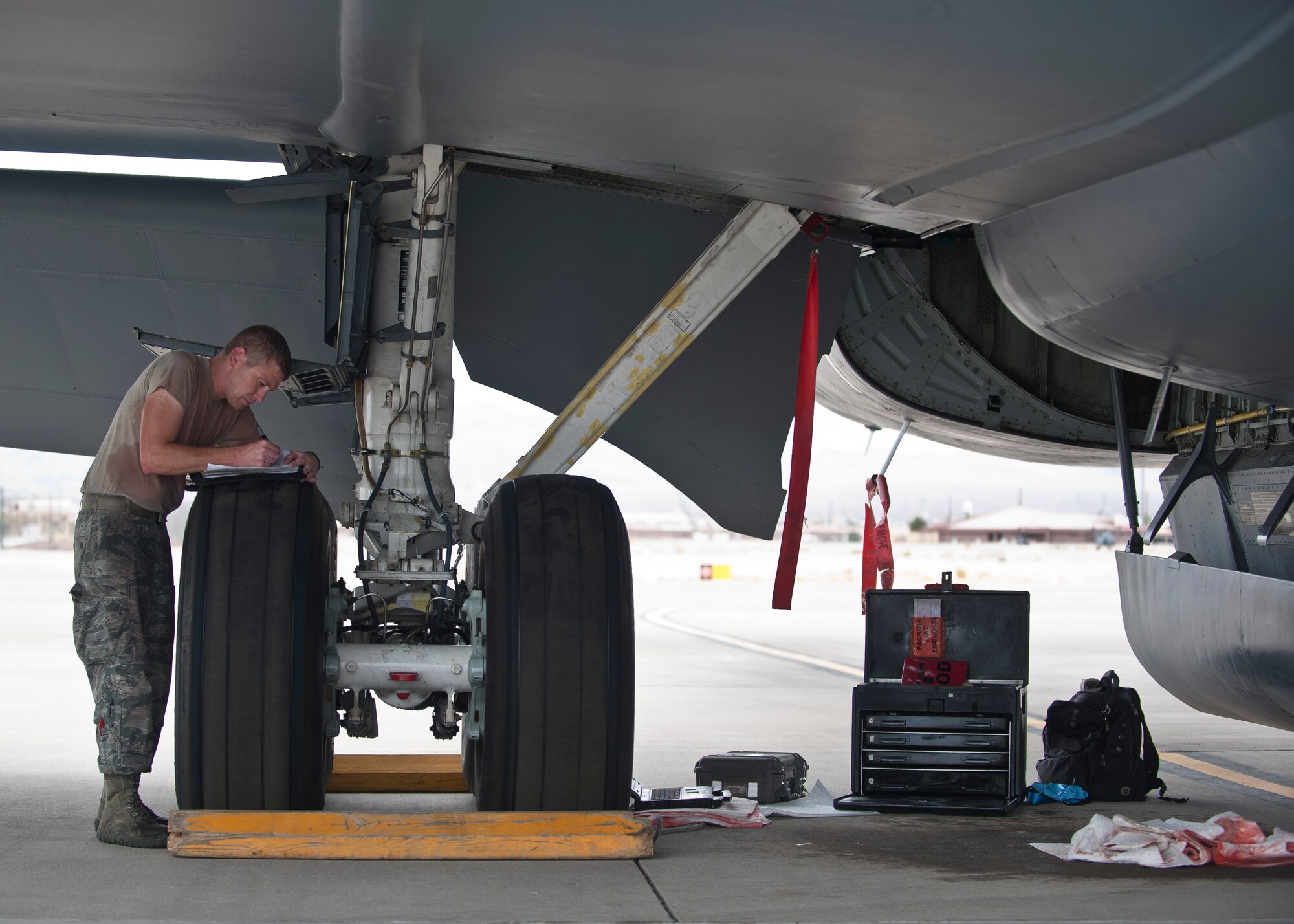 Staff Sgt. David Atteberry, an aircraft hydraulic systems technician assigned to the 92nd Aircraft Maintenance Squadron, Fairchild Air Force Base, Wash., fills out paperwork after replacing a hydraulic system relief valve on a KC-135 Stratotanker during Red Flag 15-4 at Nellis AFB, Nev., Aug. 25, 2015. Red Flag provides a series of intense air-to-air scenarios for aircrew and ground personnel to increase their combat readiness and effectiveness for future real-world operations. (U.S. Air Force photo by Staff Sgt. Siuta B. Ika)
