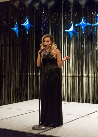 Whitney Griffin, a Navy family member, took first place at the base-level AMC Icon competition. Eight Joint Base Charleston members competed in signing competition held at the Charleston Club, Aug. 20. AMC Icon is loosely based on American Idol where service members, Department of Defense civilians and family members ages 18 and older compete for cash prizes. Griffin performed "Young and Beautiful" by Lana del Rey.(Photo by Maj. Julie Johnson, 628 Medical Group)