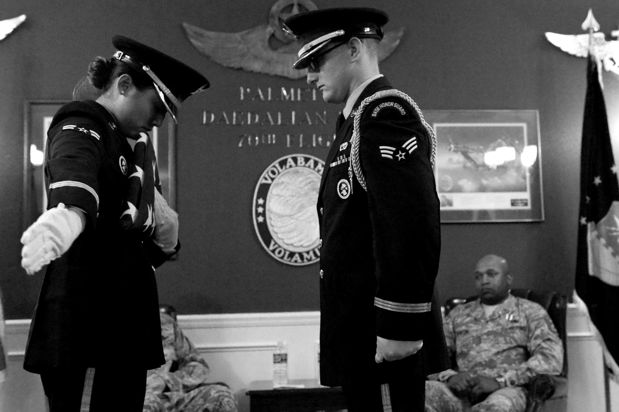 Airmen assigned to the 20th Force Support Squadron Honor Guard perform a flag folding ceremony during a retirement ceremony at Shaw Air Force Base, S.C., June 12, 2015. Honor Guardsmen provide services for those who served in the armed forces and support requests for firing parties, presentation of colors, dignified arrivals, and sabers. (U.S. Air Force photo by Senior Airman Diana M. Cossaboom/Released)