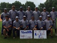 Members of the McConnell Air Force Base softball team pose with signs dedicated to the memory of Kaiser Carlile, Aug. 7, 2015, in Columbus, Ga. Carlile was the ball boy for the Liberal Bee Jays, a baseball team from Liberal, Kan., who died after being struck in the head by a player warming up in the batter’s box during a game August 1. The McConnell team dedicated their performance in the Military Worlds Softball Tournament to his memory. (Courtesy photo)