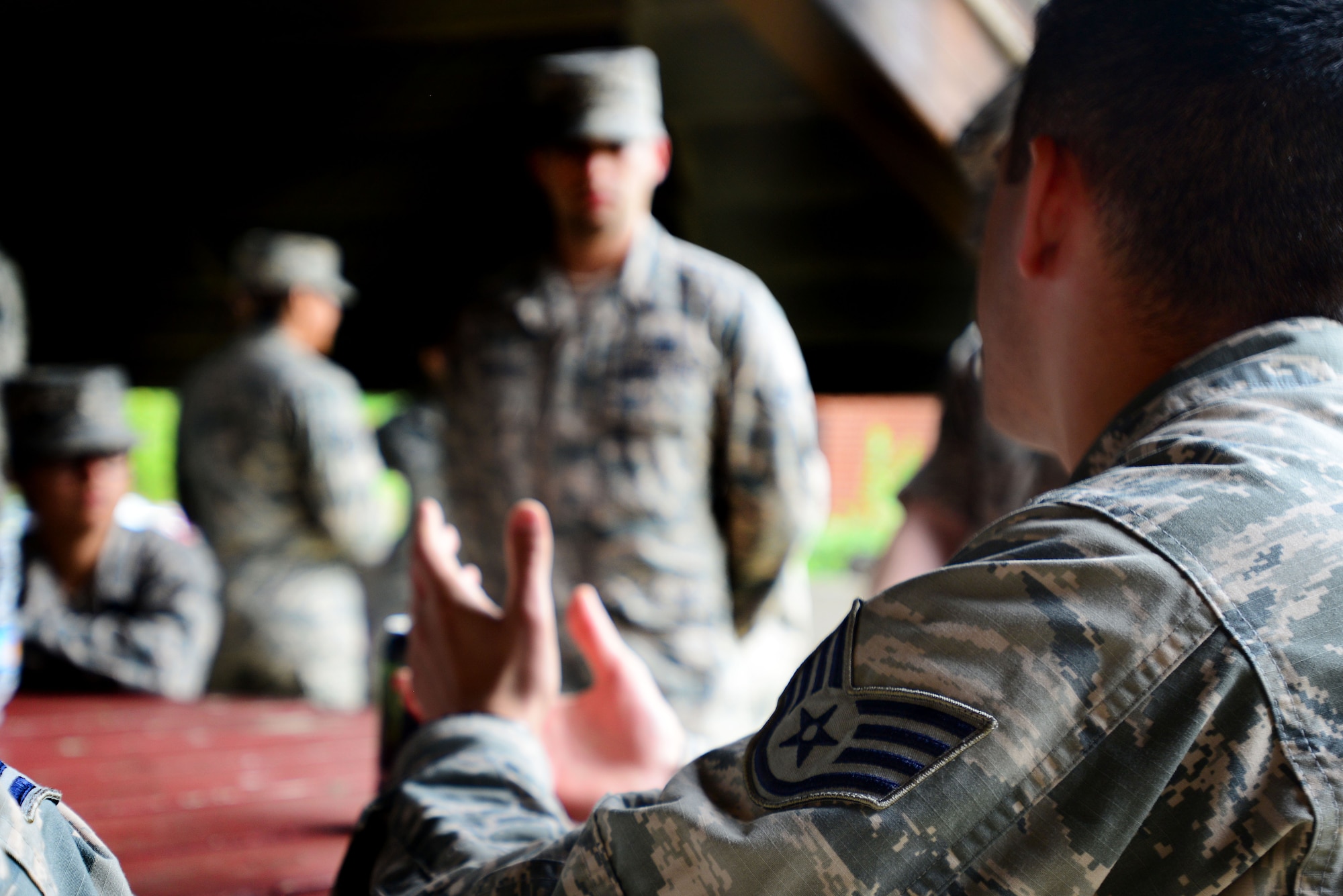 A U.S. Air Force staff sergeant talks with graduating members of a First Term Airmen Center class during a mentorship lunch at Langley Air Force Base, Va., Aug. 21, 2015. Members of the Langley Club 5/6 volunteered time to host a barbecue with the new Airmen to provide an opportunity for them to ask questions about the Air Force. (U.S. Air Force photo by Senior Airman Kimberly Nagle/Released)
