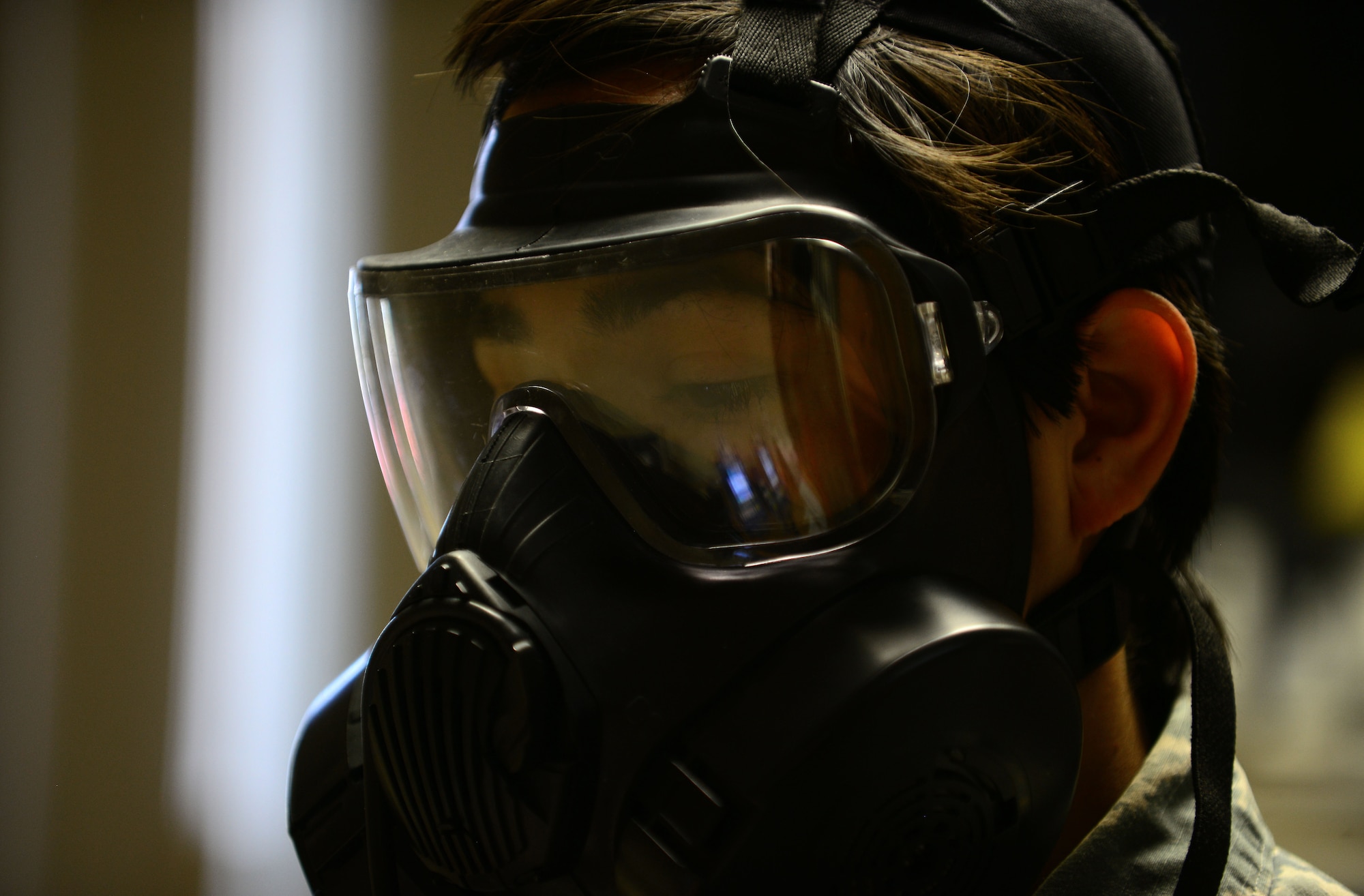 U.S. Air Force Airman 1st Class Danielle, 30th Intelligence Squadron imagery analyst, demonstrates breathing techniques during a gas mask fit-test at Langley Air Force Base, Va., Aug. 18, 2015. Airmen at the bioenvironmental office administer the test to ensure Service members’ masks properly function in case of an emergency situation. (U.S. Air Force photo by Senior Airman Kimberly Nagle/Released) (Last name withheld for operational security purposes)