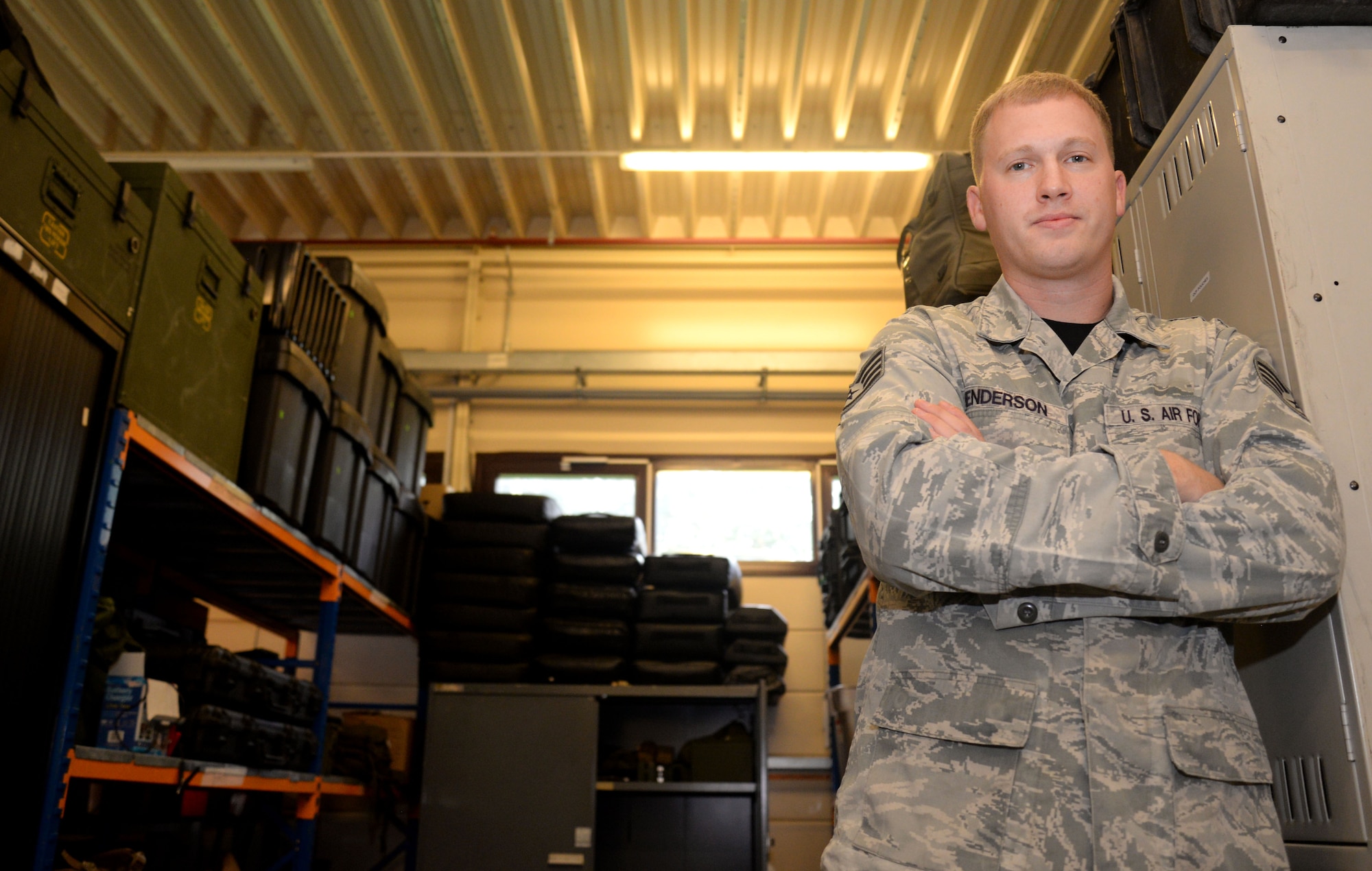 U.S. Air Force Staff Sgt. Daniel Henderson, 352nd Special Operations Support Squadron Deployed Aircraft Ground Response Element team member from Richfield, Utah, poses in front of the equipment he handles on a daily basis Aug. 21, 2015, on RAF Mildenhall, England. Henderson was selected for the Square D Spotlight for portraying the core value of Excellence in All We Do. (U.S. Air Force photo by Senior Airman Kate Thornton/Released)