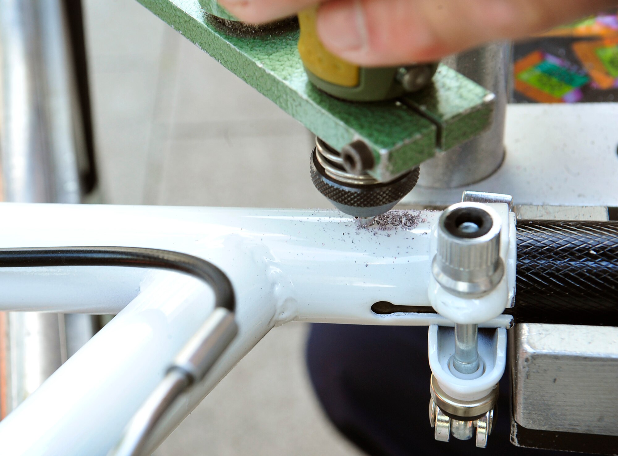 A serial number is engraved into a bicycle during a free bicycle engraving event at the Kaiserslautern Military Community Center Aug. 20, 2015, at Ramstein Air Base, Germany. The 86th Security Forces Squadron offered free engravings to military members and their families to help protect against bicycle theft. Each bicycle received a unique serial number and certificate for identification. (U.S. Air Force photo/Airman 1st Class Larissa Greatwood)