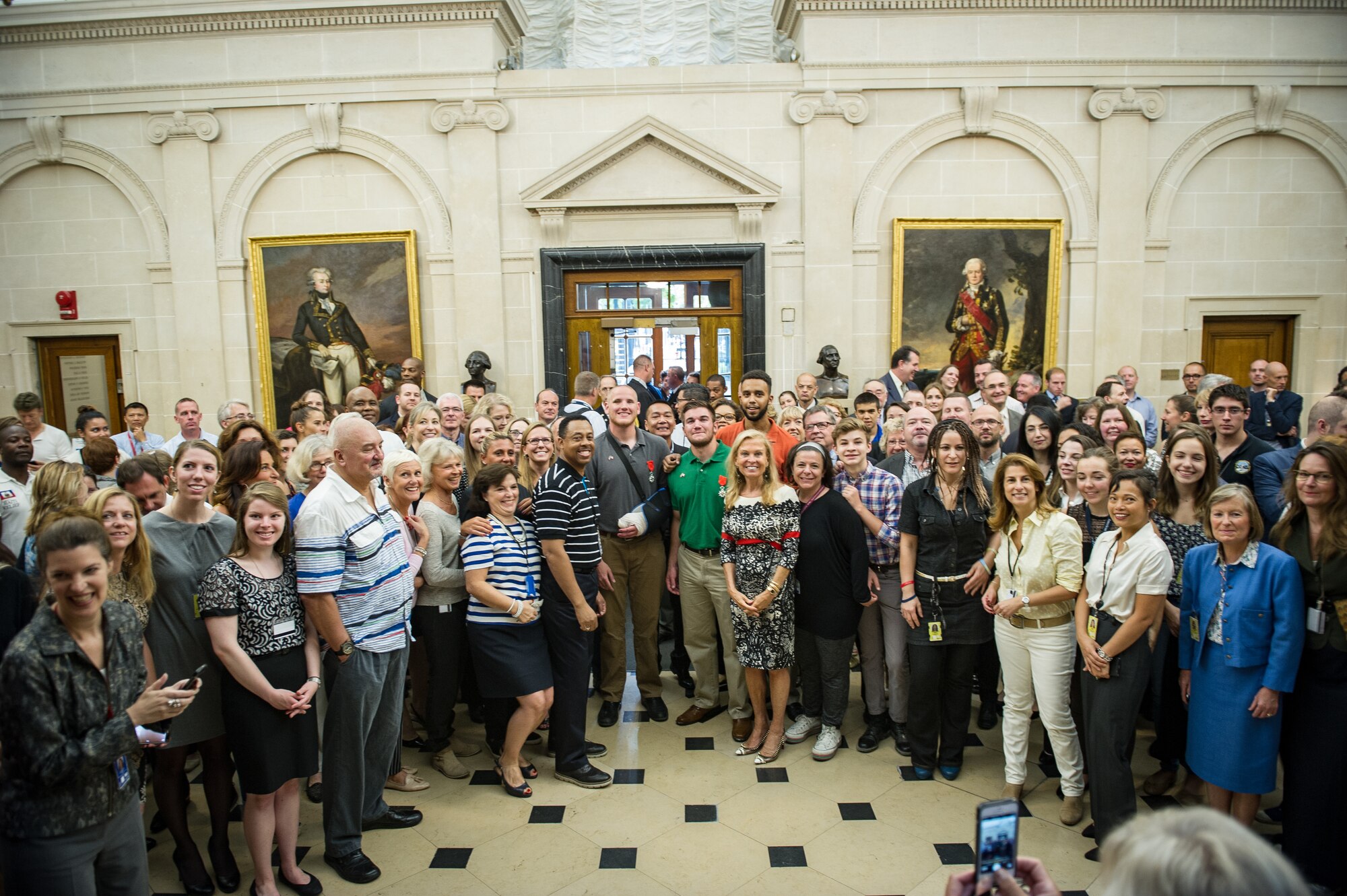 Jane Hartley, U.S. ambassador to France, speaks to her embassy staff about the heroics of the three Americans who were awarded the Legion of Honor in Paris Aug. 24, 2015, following a foiled attack  on a Frecnh train. Stone was on vacation with his childhood friends, Aleksander Skarlatos and Anthony Sadler, when an armed gunman entered their train carrying an assault rifle, a handgun and a box cutter. The three friends, with the help of a British passenger, subdued the gunman after his rifle jammed. Stone???s medical training prepared him to begin treating wounded passengers while waiting for the authorities to arrive. Stone is an ambulatnce service technician with the 65th Medical Operations Squadron stationed at Lajes Field, Azores. (U.S. Air Force photo/Tech. Sgt. Ryan Crane)