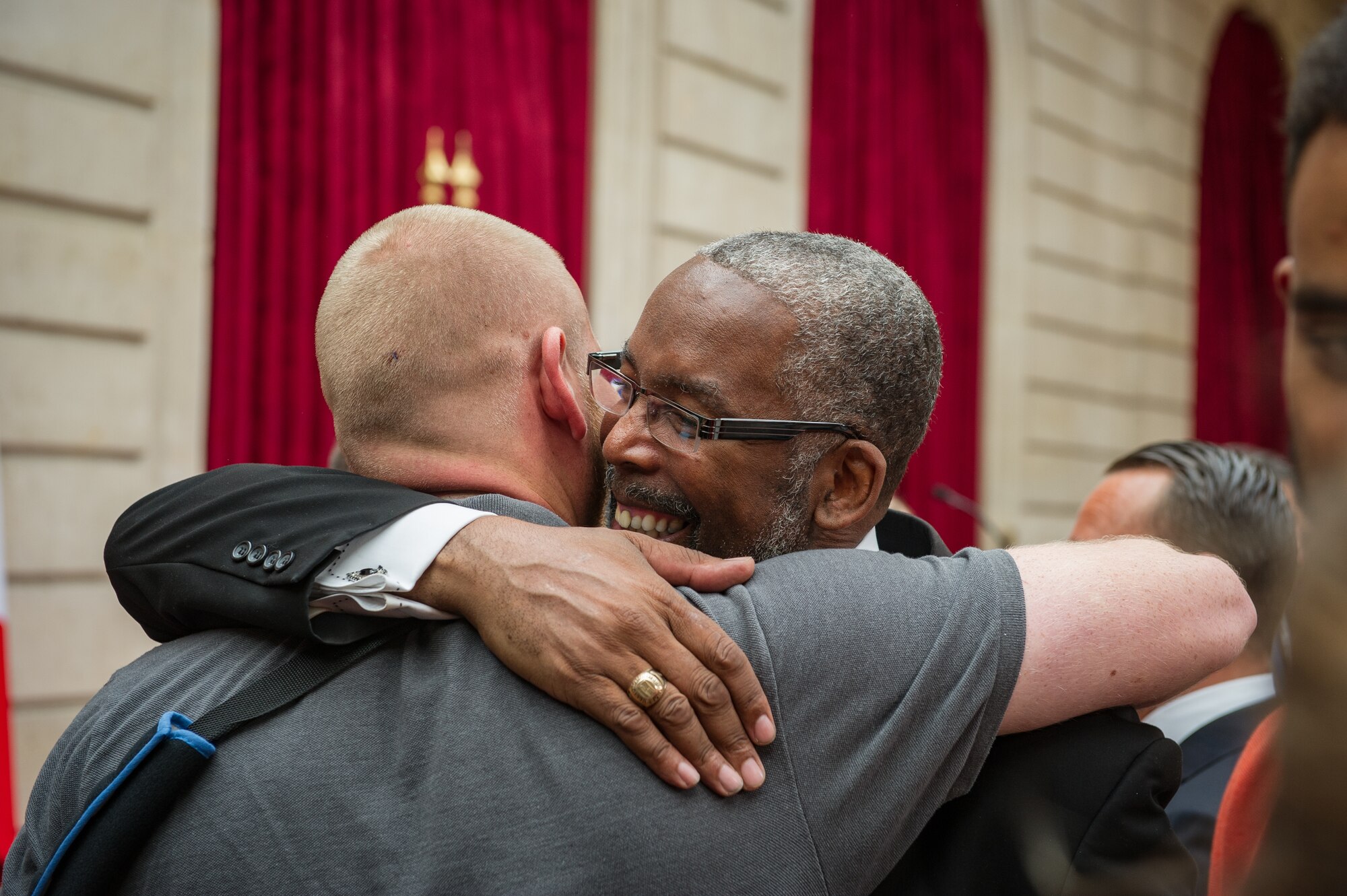 Anthony Sadler Sr. thanks U.S. Airman 1st Class Spencer Stone for keeping his son safe  Aug. 24, 2015, following a foiled attack  on a French train. Stone was on vacation with his childhood friends, Aleksander Skarlatos and Anthony Sadler, when an armed gunman entered their train carrying an assault rifle, a handgun and a box cutter. The three friends, with the help of a British passenger, subdued the gunman after his rifle jammed. Stone???s medical training prepared him to begin treating wounded passengers while waiting for the authorities to arrive. Stone is an ambulatnce service technician with the 65th Medical Operations Squadron stationed at Lajes Field, Azores. (U.S. Air Force photo/Tech. Sgt. Ryan Crane)