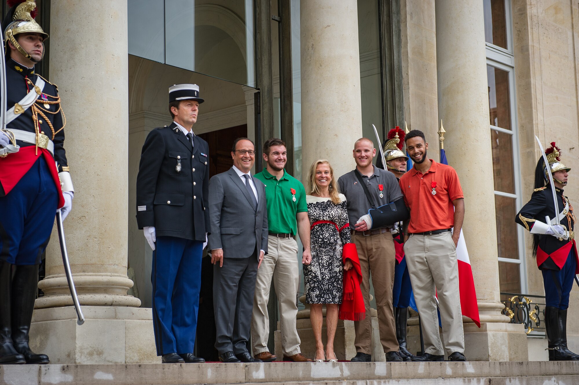 French President Fran??ois Hollande stops for a photo with Airman 1st Class Spencer Stone, Aleksander Skarlatos, Anthony Sadler and Jane Hartley, U.S. ambassador to France, after a Legion of Honor ceremony at the ??lys??e in Paris Aug. 24, 2015. Stone was on vacation with his childhood friends, Aleksander Skarlatos and Anthony Sadler, when an armed gunman entered their train carrying an assault rifle, a handgun and a box cutter. The three friends, with the help of a British passenger, subdued the gunman after his rifle jammed. Stone???s medical training prepared him to begin treating wounded passengers while waiting for the authorities to arrive. Stone is an ambulance service technician with the 65th Medical Operations Squadron stationed at Lajes Field, Azores. (U.S. Air Force photo/Tech. Sgt. Ryan Crane)