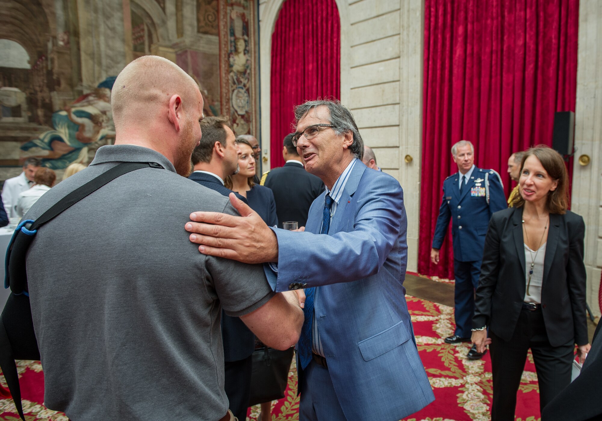 Airman 1st Class Spencer Stone thanks the doctor who initially treated him after a Legion of Honor ceremony at the ??lys??e in Paris Aug. 24, 2015. Stone was on vacation with his childhood friends, Aleksander Skarlatos and Anthony Sadler, when an armed gunman entered their train carrying an assault rifle, a handgun and a box cutter. The three friends, with the help of a British passenger, subdued the gunman after his rifle jammed. Stone???s medical training prepared him to begin treating wounded passengers while waiting for the authorities to arrive. Stone is an ambulance service technician with the 65th Medical Operations Squadron stationed at Lajes Field, Azores. (U.S. Air Force photo/Tech. Sgt. Ryan Crane)