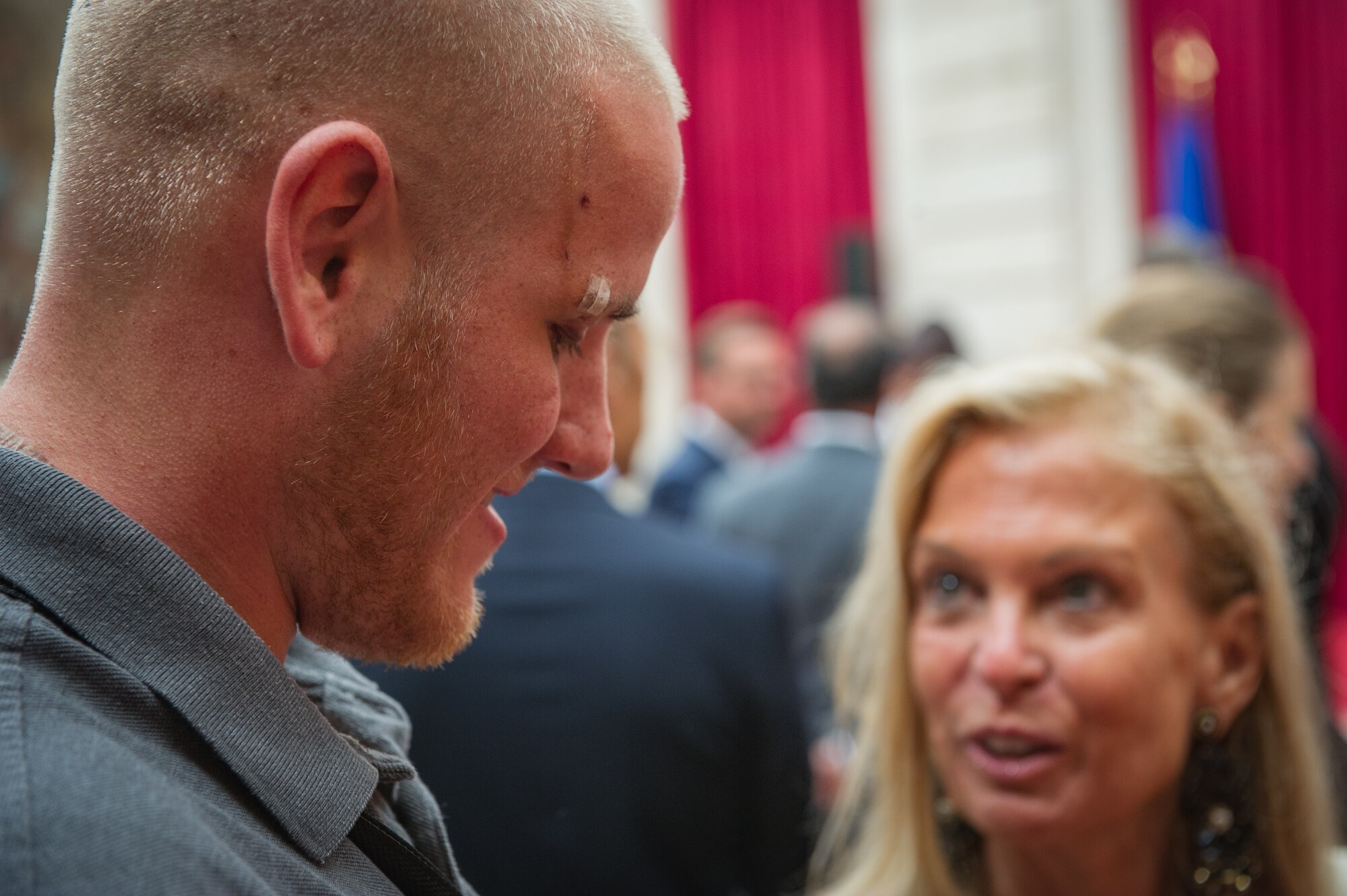 U.S. Airman 1st Class Spencer Stone speaks with Jane Hartley, the U.S. ambassador to France after a Legion of Honor ceremony in Paris Aug. 24, 2015, following a foiled attack on a French train. Stone was on vacation with his childhood friends, Aleksander Skarlatos and Anthony Sadler, when an armed gunman entered their train carrying an assault rifle, a handgun and a box cutter. The three friends, with the help of a British passenger, subdued the gunman after his rifle jammed. Stone???s medical training prepared him to begin treating wounded passengers while waiting for the authorities to arrive. Stone is an ambulance service technician with the 65th Medical Operations Squadron stationed at Lajes Field, Azores. (U.S. Air Force photo/Tech. Sgt. Ryan Crane)