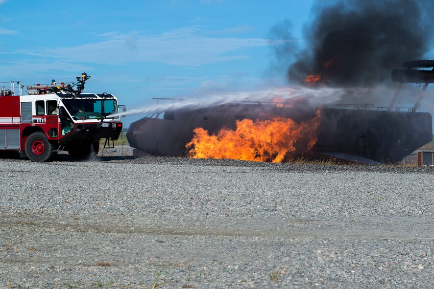 A 23d Civil Engineer Squadron stryker fire truck sprays water on a simulated aircraft fire during a live-fire burn exercise Aug. 20, 2015, at Moody Air Force Base, Ga. These quarterly exercises provide training and keep fire team members prepared with the techniques needed to control an aircraft fire. (U.S. Air Force photo by Airman 1st Class Kathleen D. Bryant/Released)

