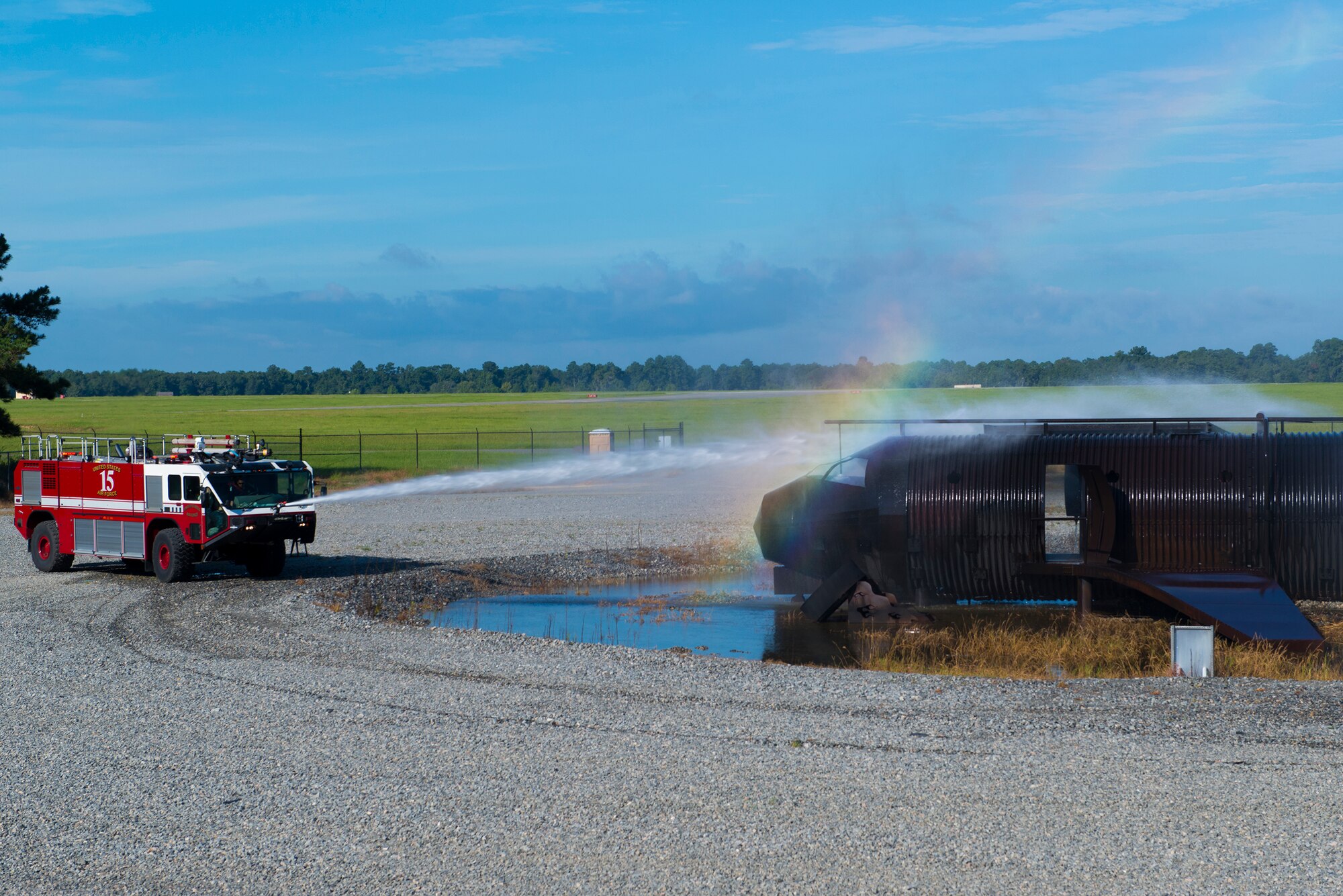 A 23d Civil Engineer Squadron stryker fire truck sprays water on a simulated aircraft fire during a live-fire burn exercise Aug. 20, 2015, at Moody Air Force Base, Ga. Two stryker fire trucks and one rapid intervention vehicle alternated spraying the aircraft to ensure a continuous flow of water to the aircraft fire. (U.S. Air Force photo by Airman 1st Class Kathleen D. Bryant/Released)


