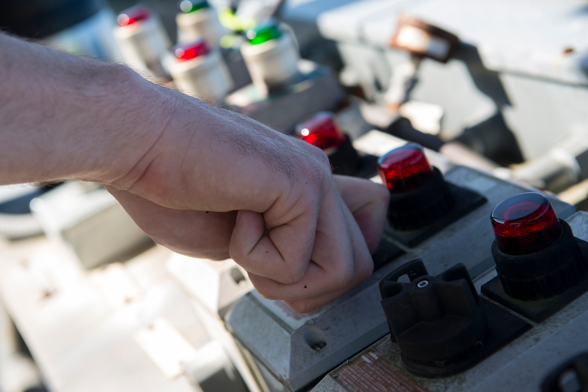 A 23d Civil Engineer Squadron fire protection crew chief turns a switch to start a fire during a live-fire burn exercise Aug. 20, 2015, at Moody Air Force Base, Ga. Fire team members controlled the fire during the exercise from a tower using controls and buttons. (U.S. Air Force photo by Airman 1st Class Kathleen D. Bryant/Released)

