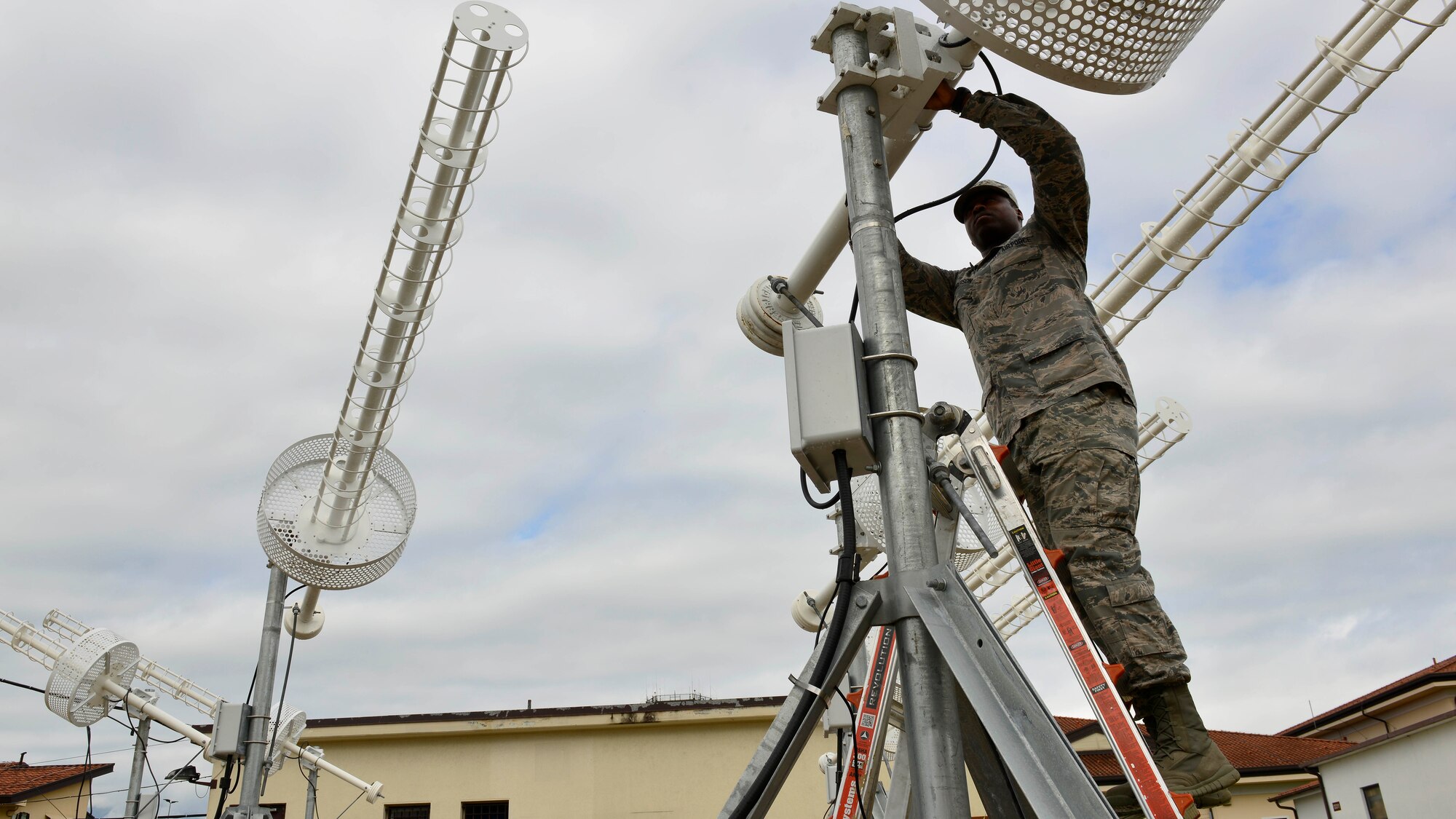 U.S. Air Force Airman Basic Charles Anderson, 31st Communication Squadron radio systems technician, checks to ensure a Mystic Star antenna is positioned correctly, Aug. 25, 2015, at Aviano Air Base, Italy. The antennas provide a communication channel back to the U.S. for dignitaries flying between the mid-Atlantic and Asia. (U.S. Air Force photo by Airman 1st Class Cary Smith/Released)
