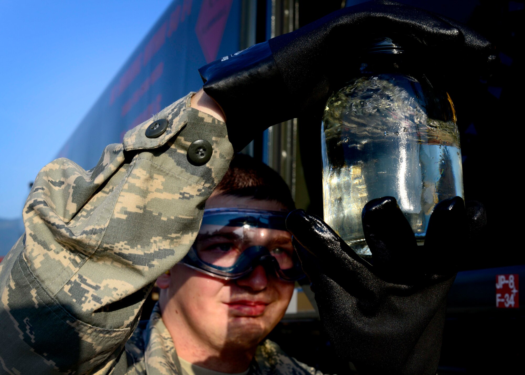 U.S. Air Force Airman 1st Class Austin Hayes, 31st Logistics Readiness Squadron petroleum oils and lubricants mobile distribution operator visually inspects fuel for color, water and sediments, Aug. 26, 2015, at Aviano Air Base, Italy. Airmen from POL check for contaminates in fuel stored in R-11 refueling trucks at the beginning of each duty day. (U.S. Air Force photo by Senior Airman Areca T. Wilson/Released)