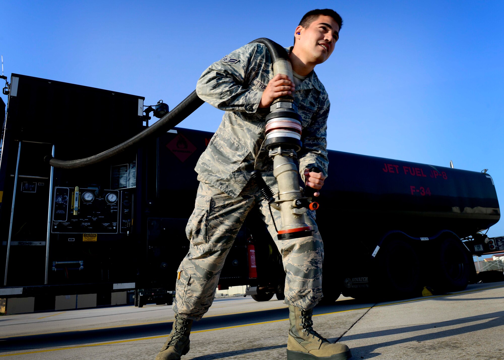 U.S. Air Force Airman 1st Class Sergio Fortich, 31st Logistics Readiness Squadron petroleum oils and lubricants mobile distribution operator, pulls a hose from an R-11 refueling truck, Aug. 26, 2015, at Aviano Air Base, Italy. The hoses are pressurized and required to be checked for leaks monthly. (U.S. Air Force photo by Senior Airman Areca T. Wilson/Released))
