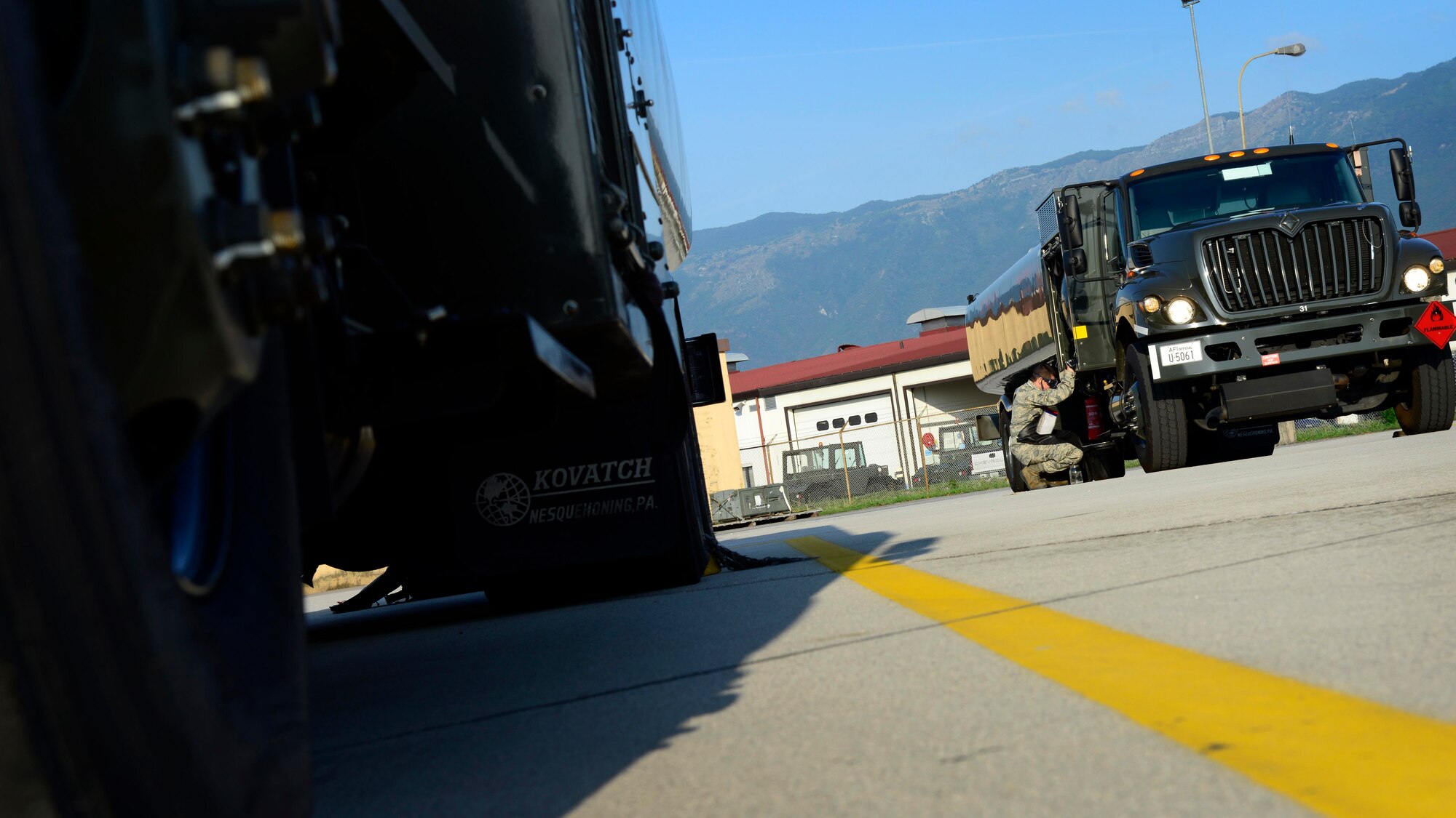 U.S. Air Force Airman 1st Class Austin Hayes, 31st Logistics Readiness Squadron petroleum oils and lubricants mobile distribution operator visually inspects fuel for color, water and sediments, Aug. 26, 2015, at Aviano Air Base, Italy. Airmen from POL ensure the correct amount of fuel is delivered to various locations on base. (U.S. Air Force photo by Senior Airman Areca T. Wilson/Released)
