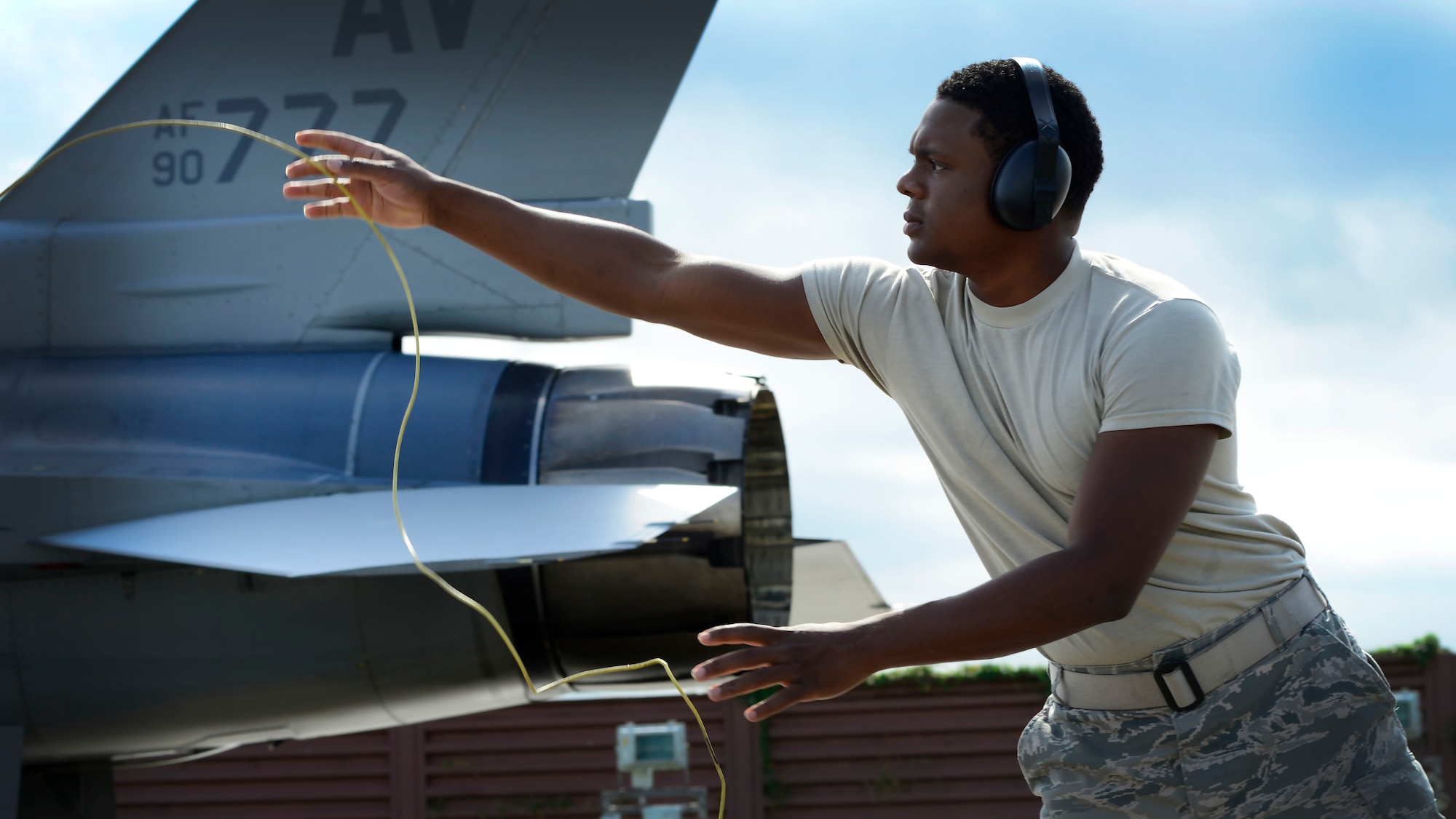U.S. Air Force Airman Samuel Harrell, 31st Logistics Readiness Squadron petroleum oils and lubricants facility technician, helps remove bonding cords after a hot refueling operation, Aug. 25, 2015, at Aviano Air Base, Italy. Airmen from POL ensure the correct amount of fuel is delivered on location, on time. (U.S. Air Force photo by Senior Airman Areca T. Wilson/Released)